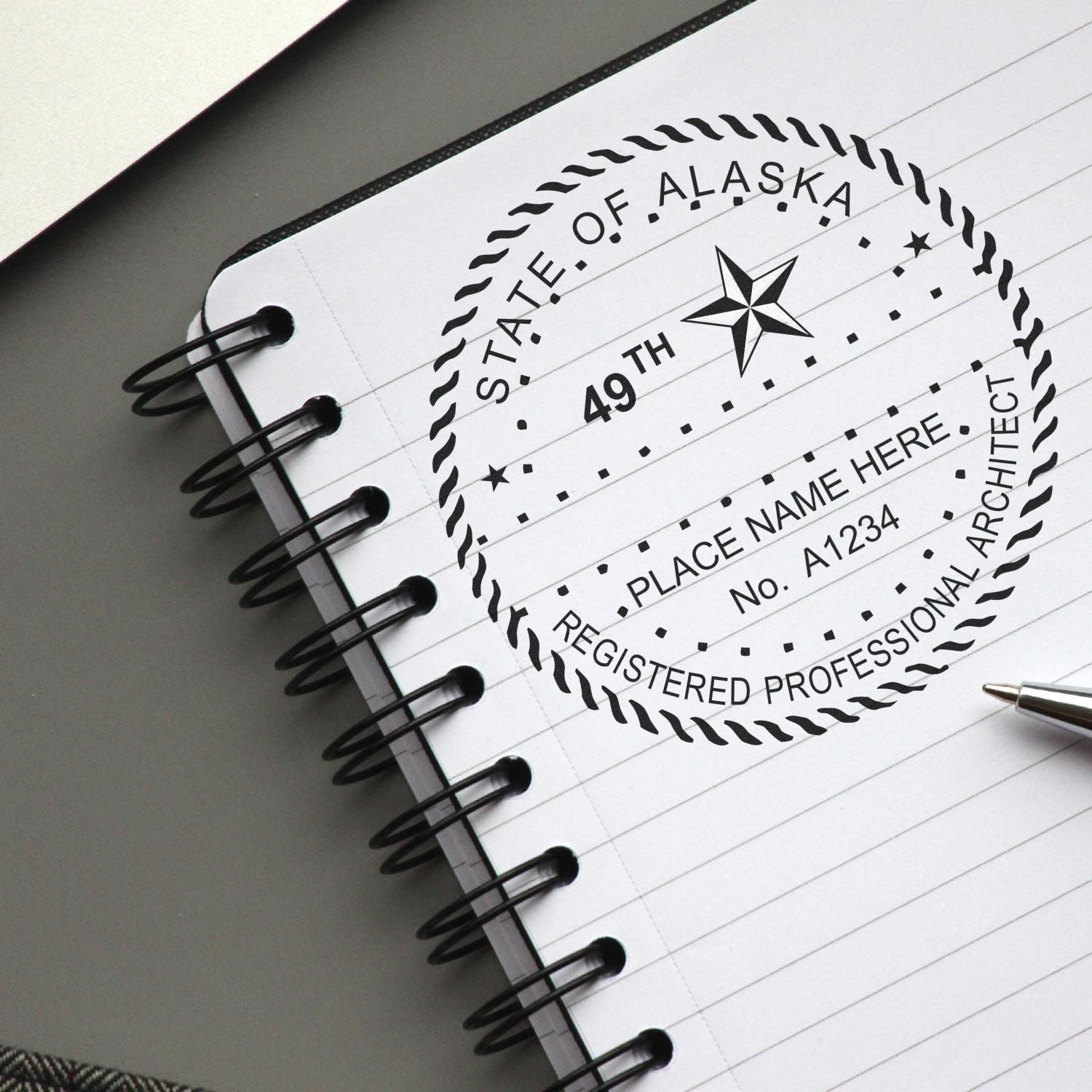 Seal the Deal: Alaska Architect Seals for Building Excellence Feature Image - A notebook with an Alaska architect seal and a pen.