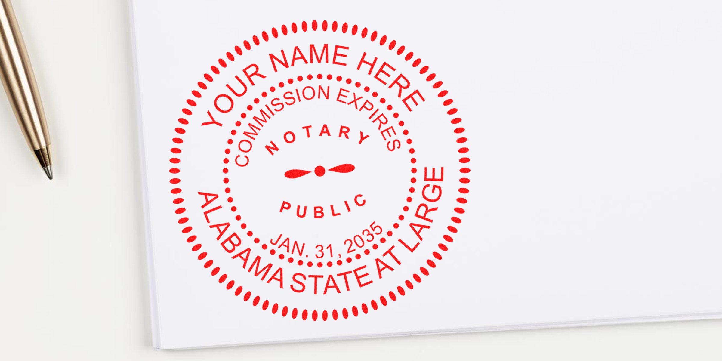 Red circular notary public seal stamped on white paper reading "YOUR NAME HERE", "Alabama State At Large", commission expires Jan. 31, 2035, with a gold ballpoint pen nearby