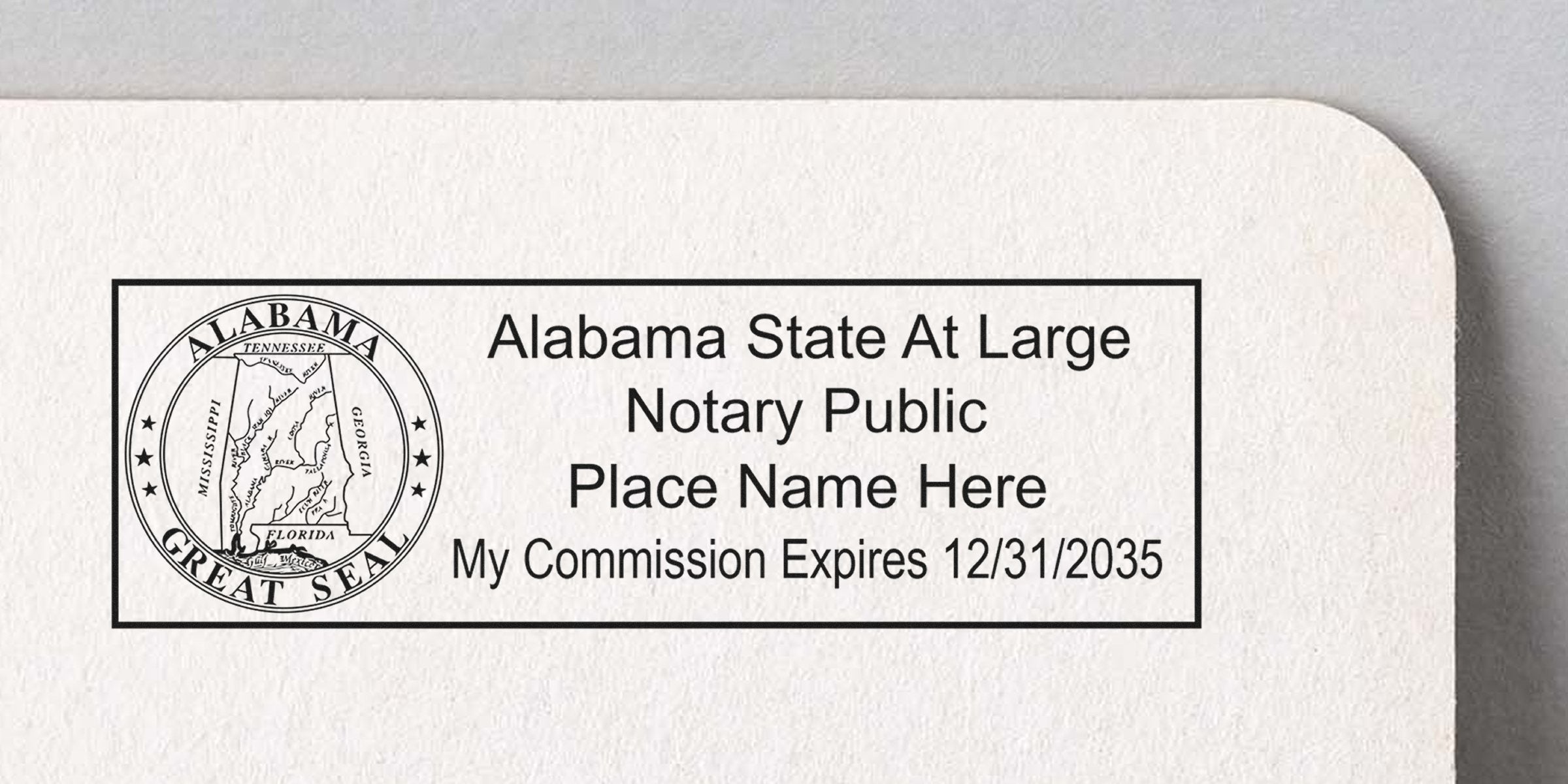 Black ink Alabama State At Large Notary Public stamp with Great Seal, placeholder "Place Name Here" and "My Commission Expires 12/31/2035" inside rectangular border on textured white paper.