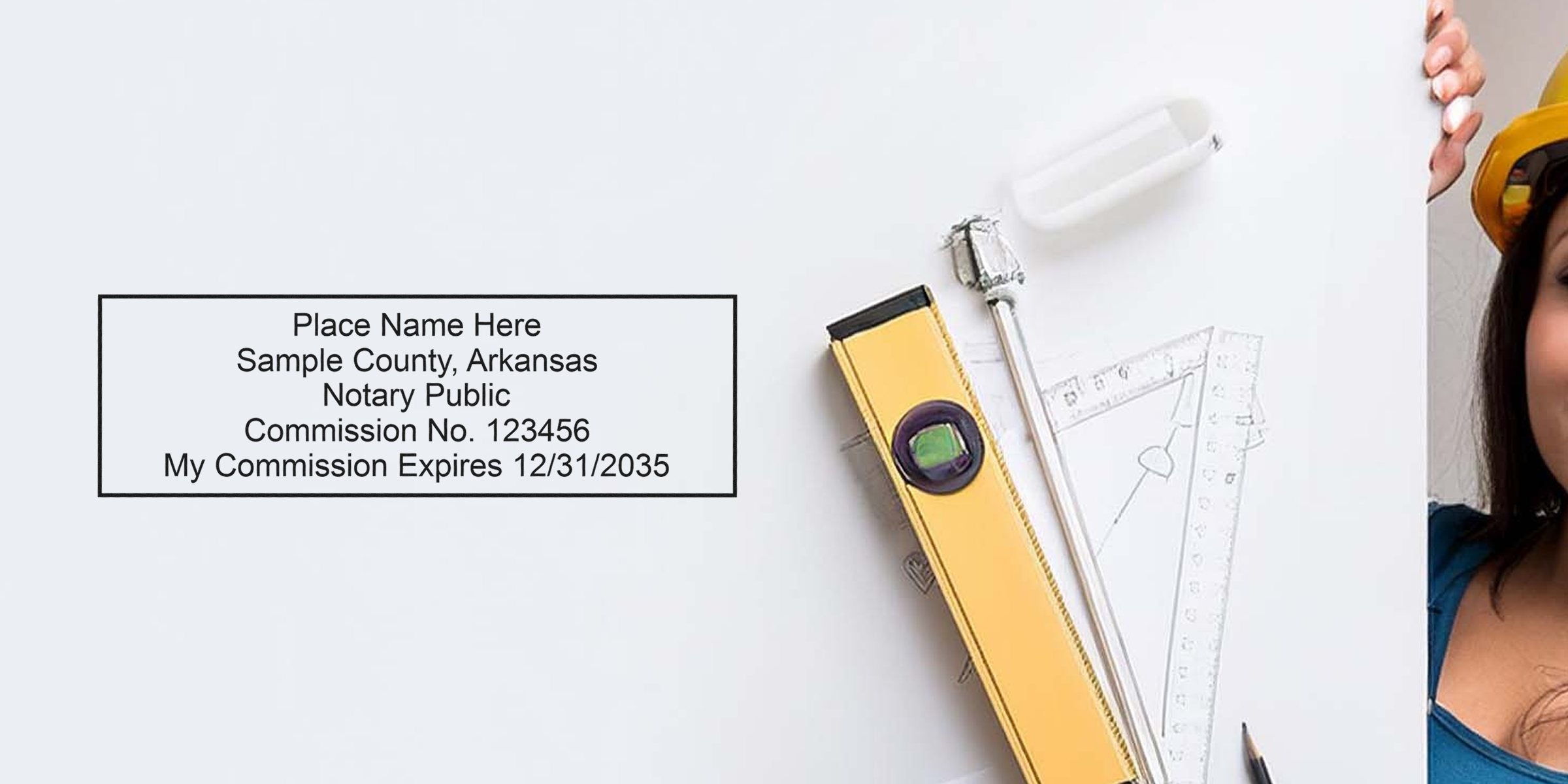 Sample notary stamp imprint on white board beside drafting tools — yellow spirit level, compass, triangular ruler and pencil — with partial view of a person in a yellow hard hat and blue shirt at right.