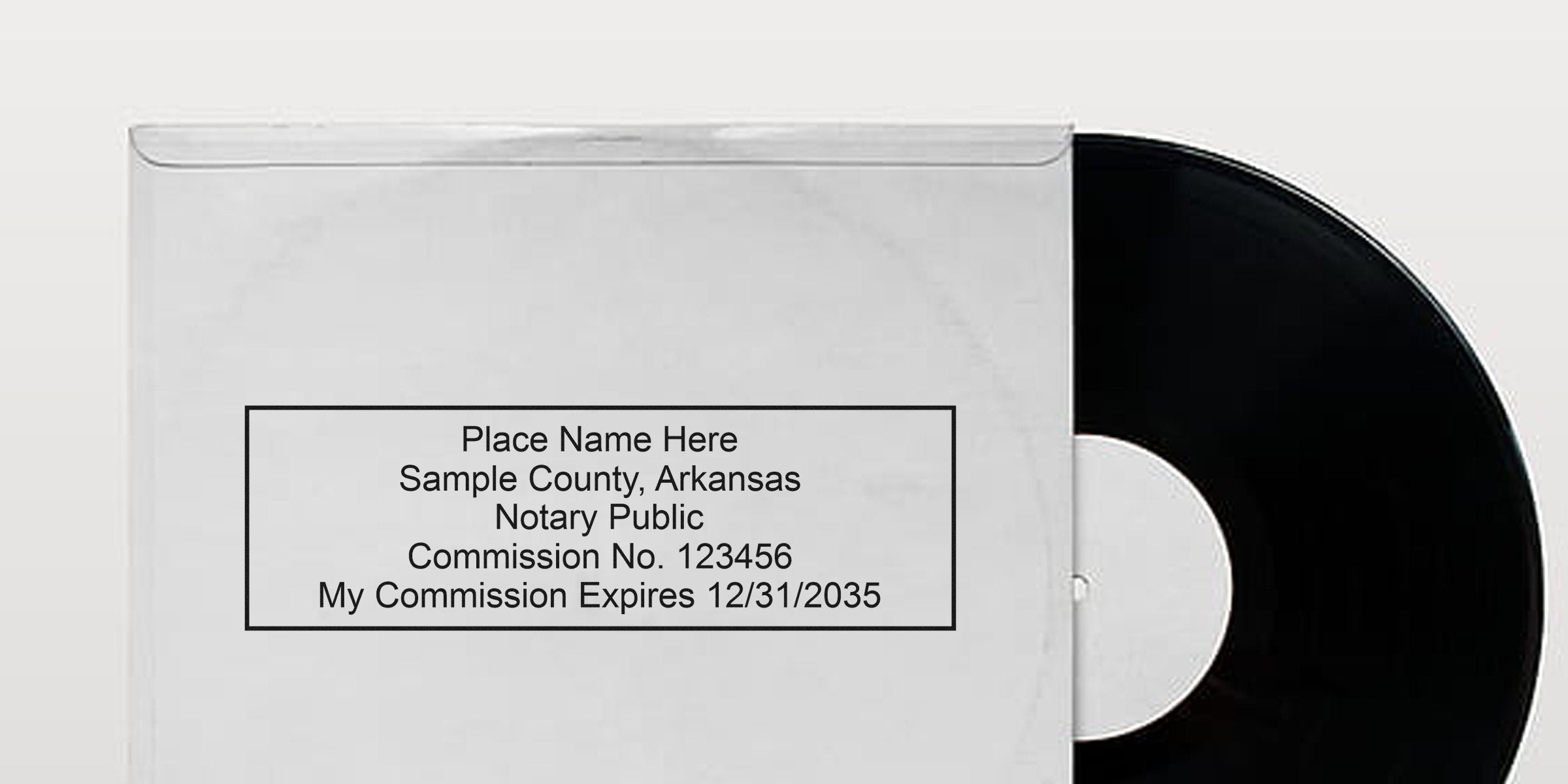Black vinyl record half-exposed from a white paper sleeve featuring a printed sample notary stamp box with placeholder name, sample county Arkansas, commission number and expiration date.
