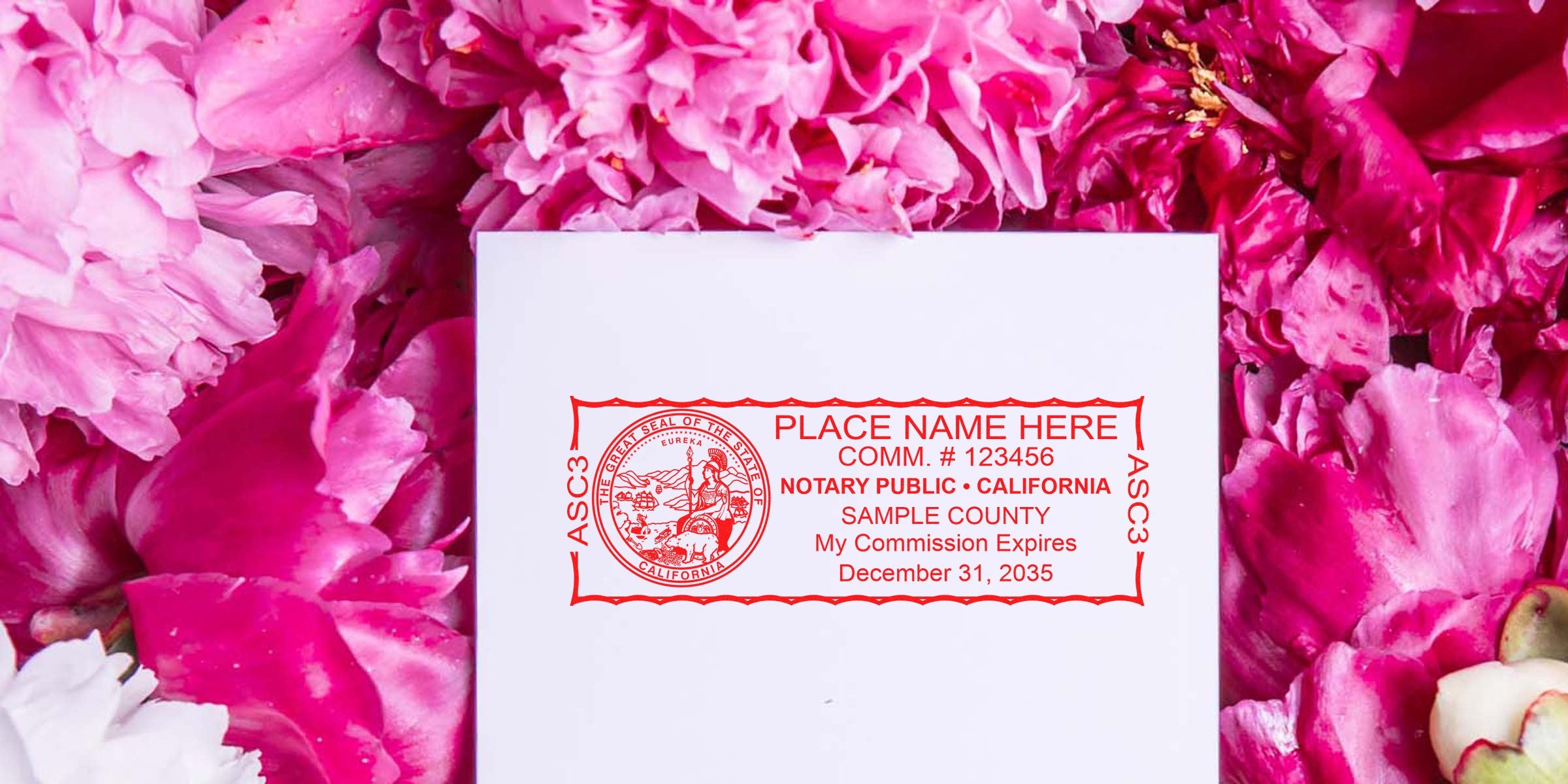 Red California notary public stamp impression on white card surrounded by pink peony petals, showing customizable place name, commission number and expiration date for notary stationery and seals.
