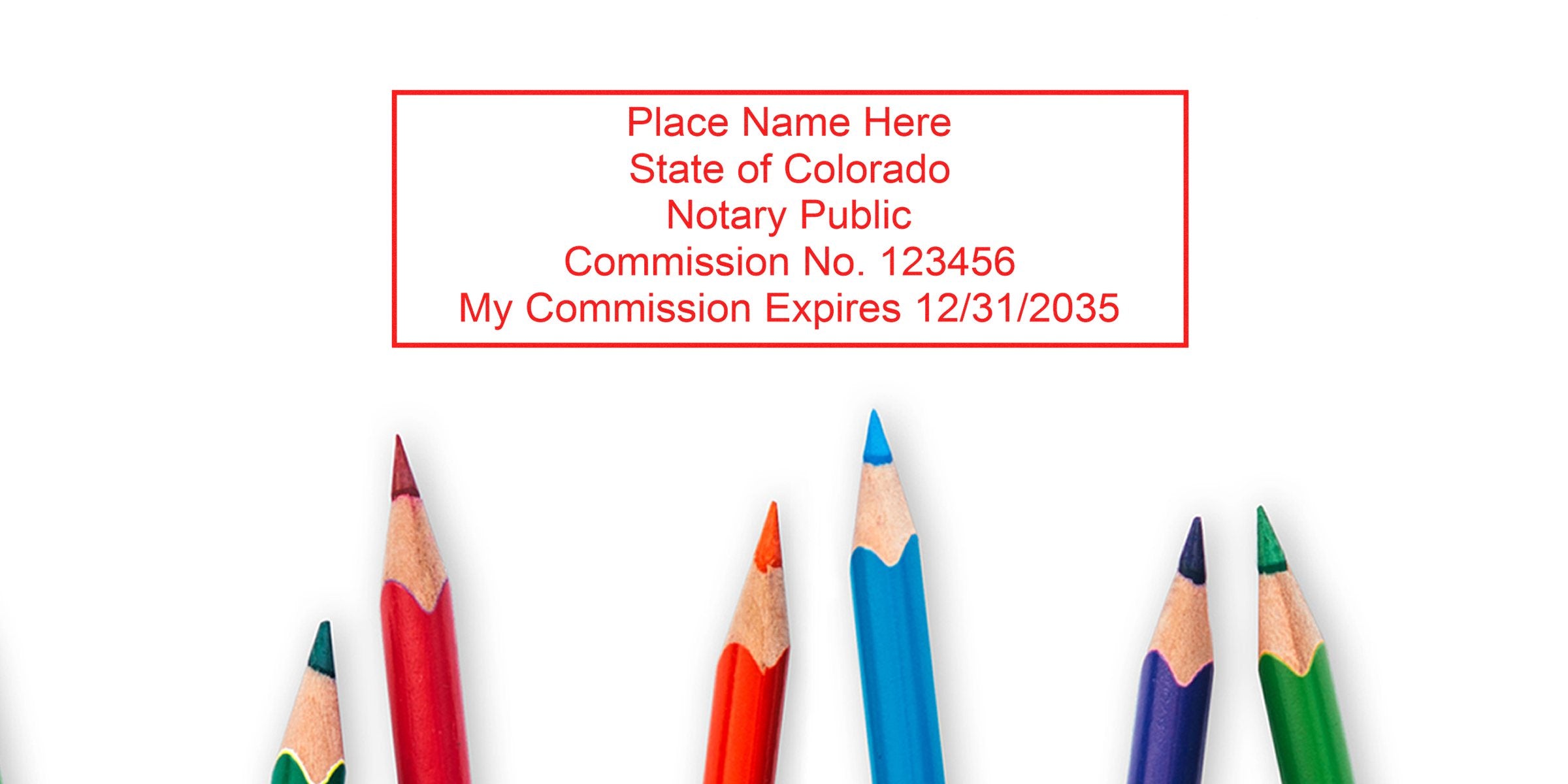Red rectangular notary stamp template reading "Place Name Here State of Colorado Notary Public Commission No. 123456 My Commission Expires 12/31/2035" above sharpened red, blue, green and purple colored pencils on white background