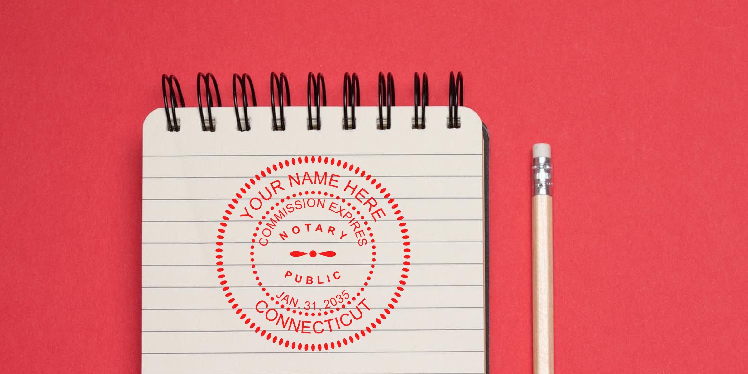 Top spiral notebook on red background with lined paper showing a red circular Connecticut notary public stamp reading "Your Name Here, Commission Expires Jan. 31, 2035" and a wooden pencil with eraser alongside.