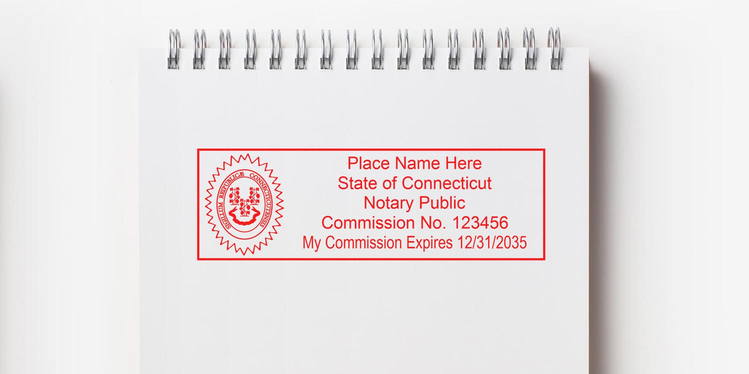 Red rectangular Connecticut notary stamp on white spiral notebook, state seal left, placeholder name, commission number and expiration date — notary public stamp mockup.
