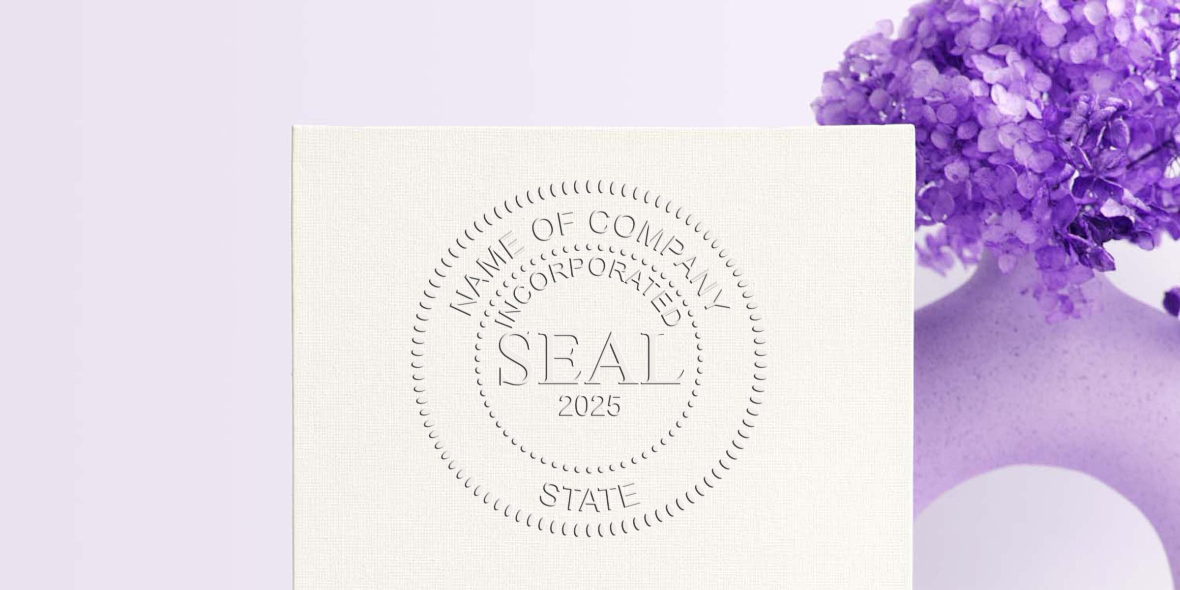 Circular embossed seal with the words “NAME OF COMPANY INCORPORATED SEAL 2025” on a light beige surface.