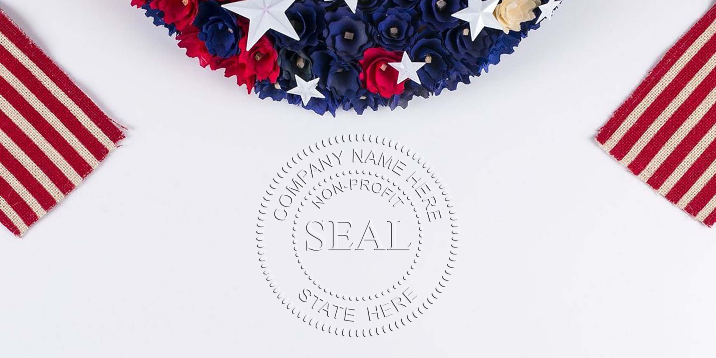 A patriotic decorative seal with a circular embossed stamp reading SEAL, surrounded by “COMPANY NAME HERE,” “NON-PROFIT,” and “STATE HERE,” flanked by red-and-white striped ribbons and a blue, white, and red floral arrangement with white stars.