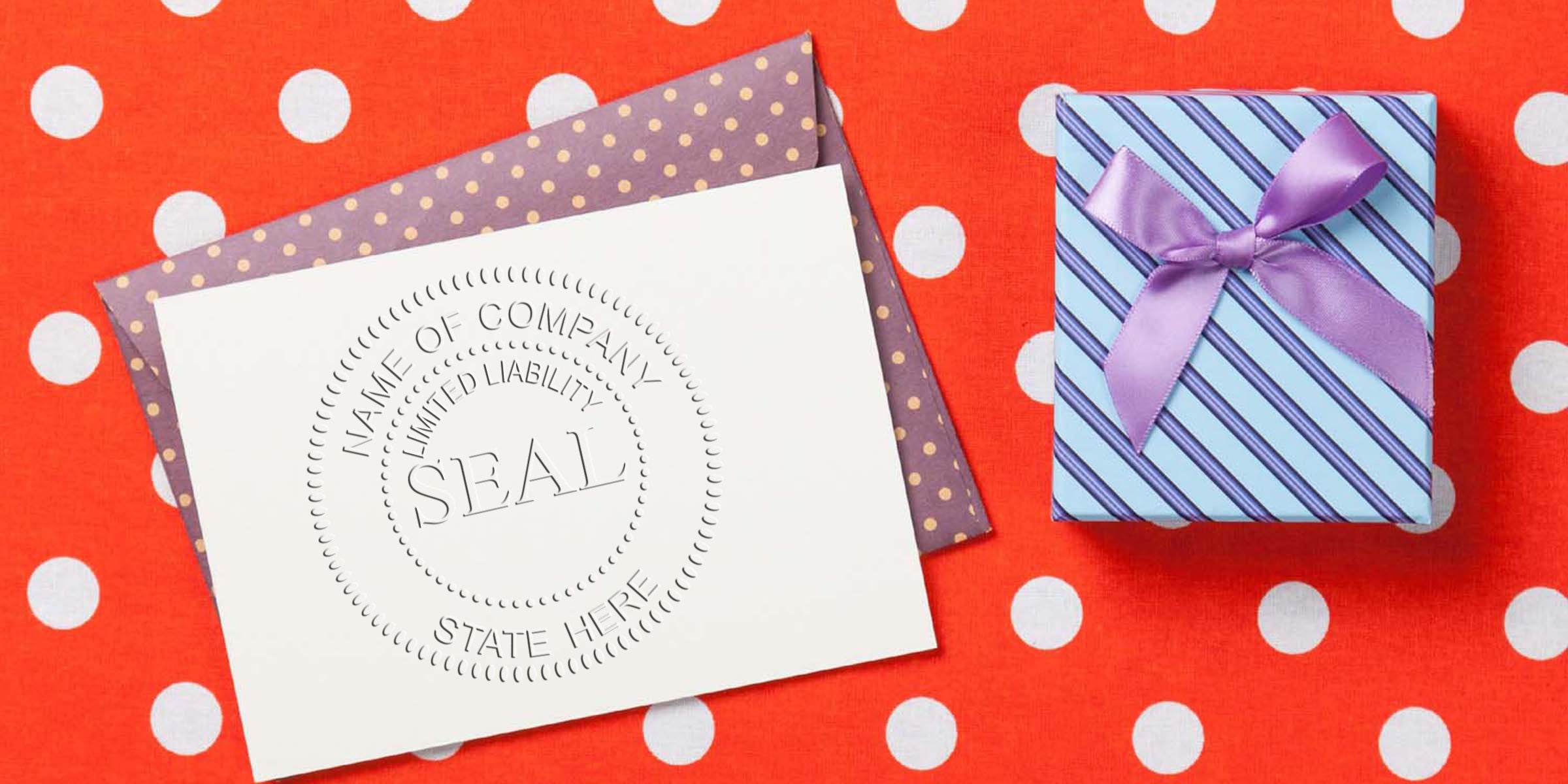 Gift card and present: a white card with a circular “SEAL” design rests on a purple polka-dot envelope beside a striped blue gift box with a purple ribbon on a red polka-dot background.
