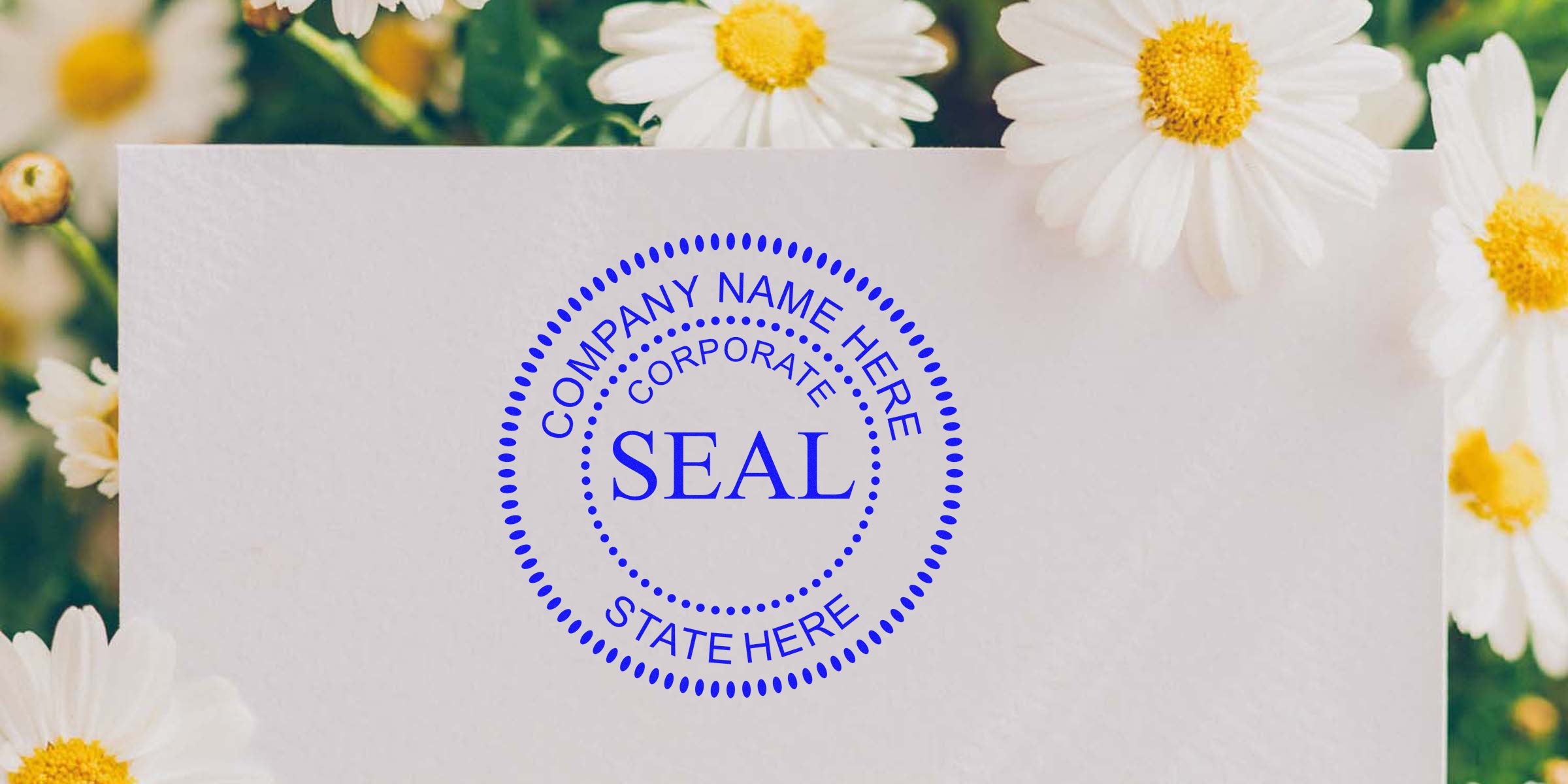 Blue circular company seal stamp on a white card, with daisies in the background.