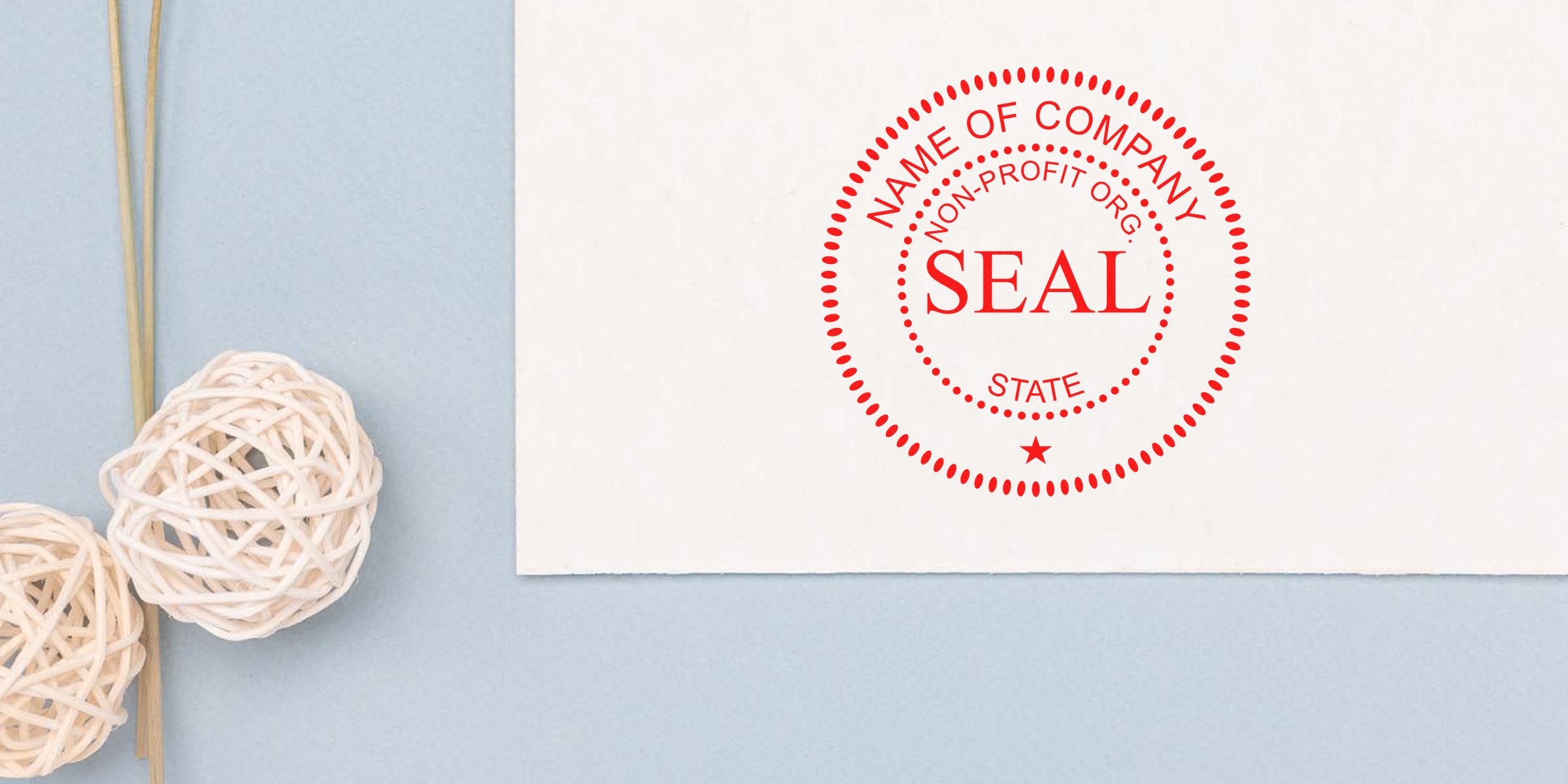 Red circular seal on a white card with the words “NAME OF COMPANY SEAL STATE” in red, placed on a light blue background with decorative rattan balls on the left.