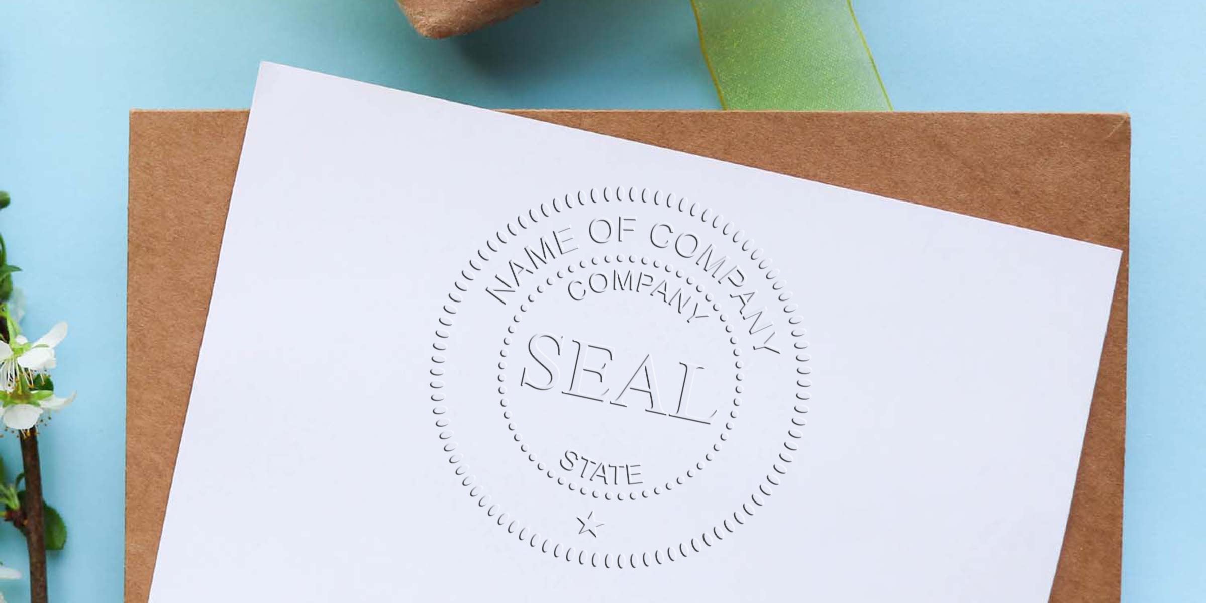 Embossed circular seal on a white sheet laid over a brown envelope, with a blue background and a small plant stem on the left.
