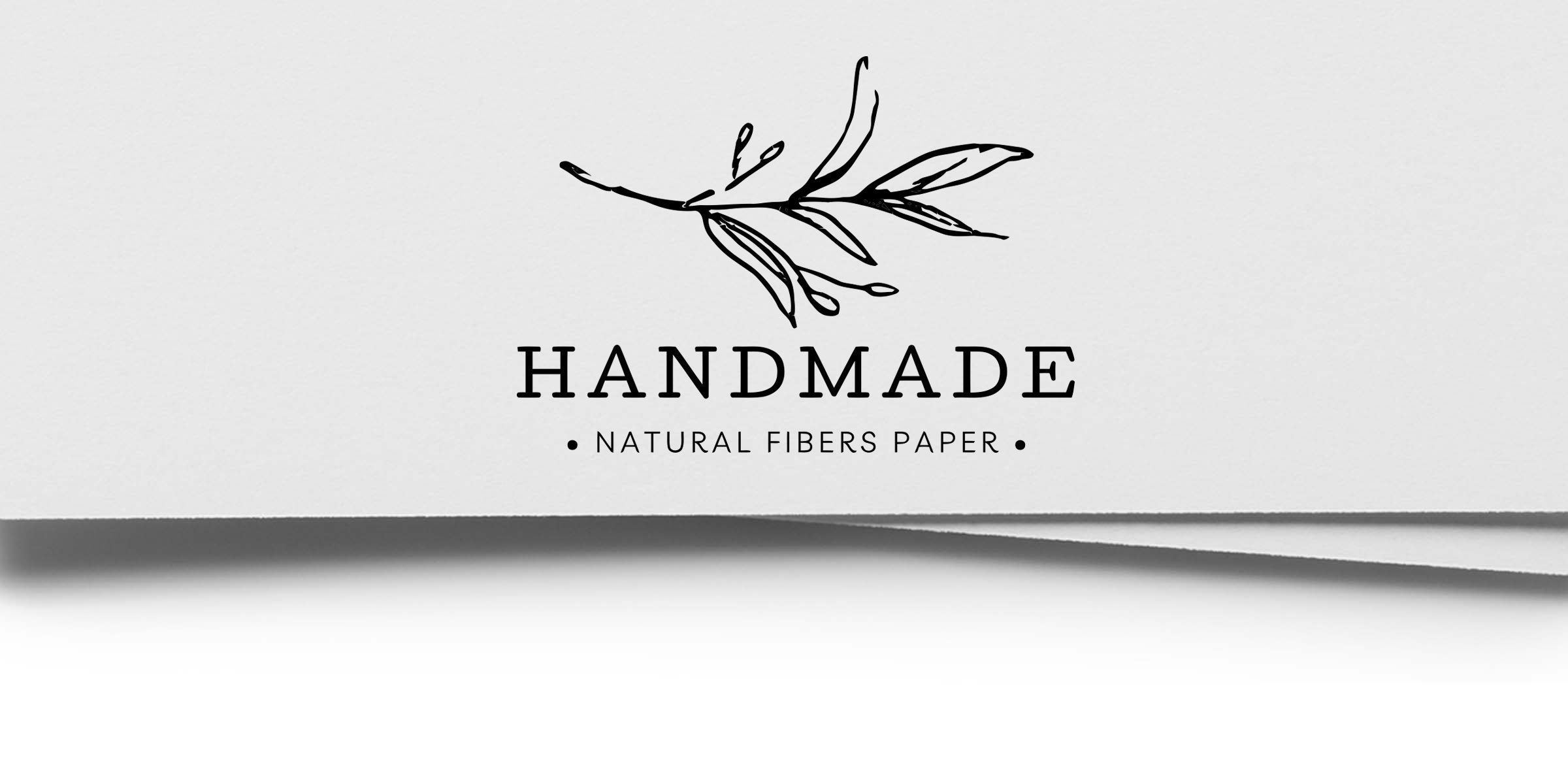 Minimal black botanical branch logo reading "HANDMADE" with "Natural Fibers Paper" tagline on textured white paper — handmade paper branding, natural fibers, eco-friendly stationary.