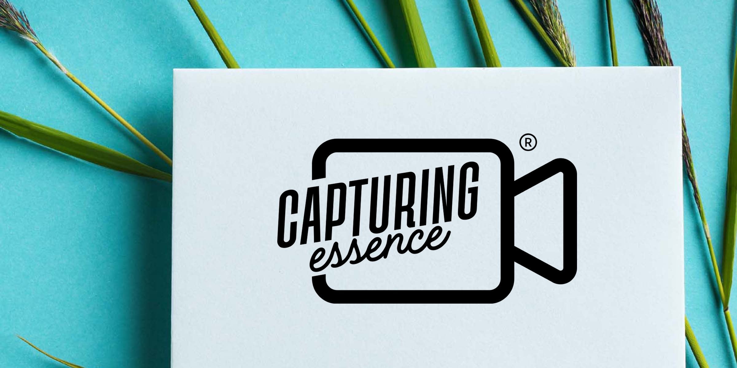Capturing Essence black logo inside a camera icon on a white card, teal background with green reeds and grasses