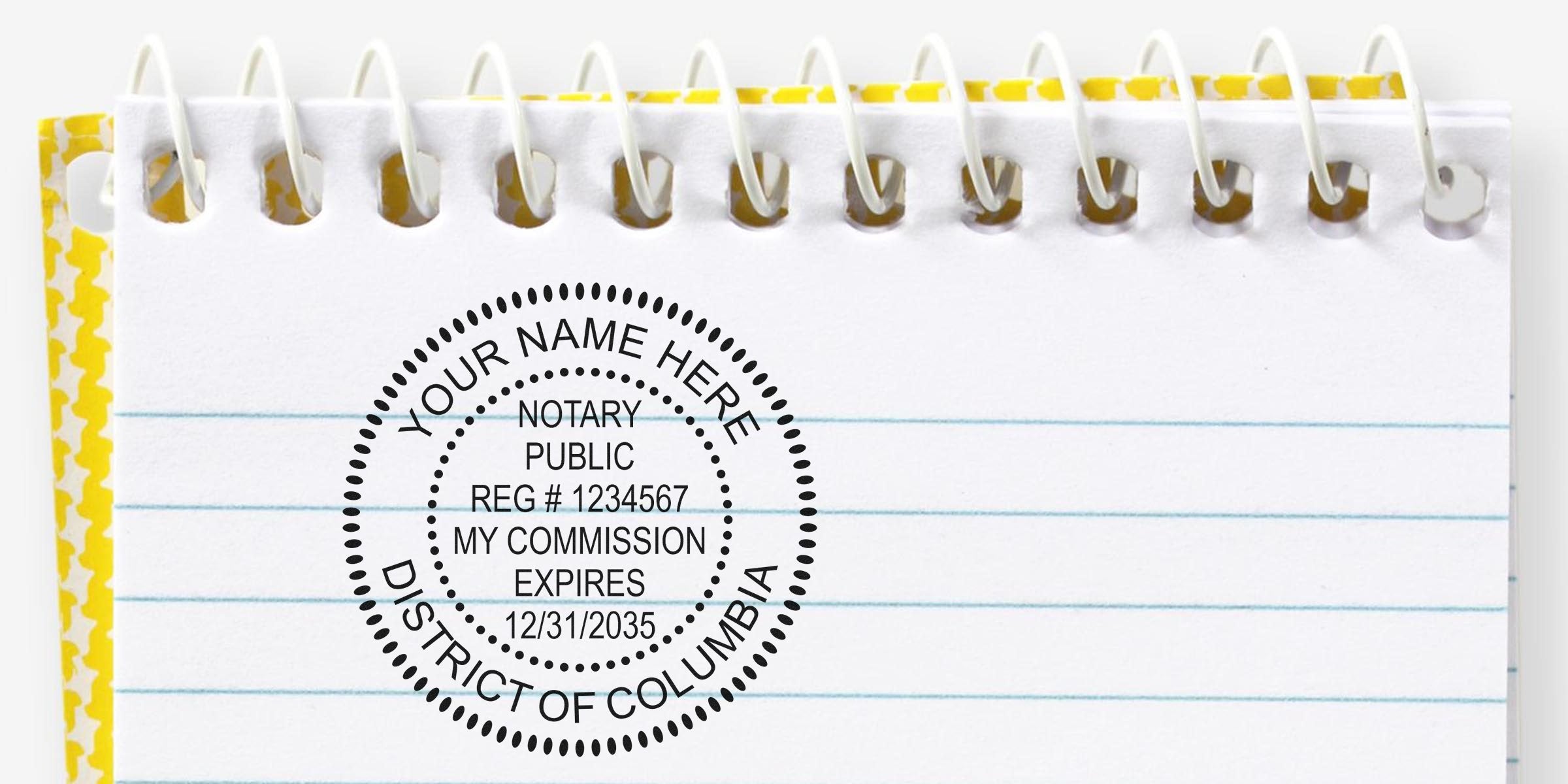 Spiral-bound lined notepad top with yellow patterned edge and circular District of Columbia notary public stamp graphic reading "Your Name Here", Reg #1234567, commission expires 12/31/2035