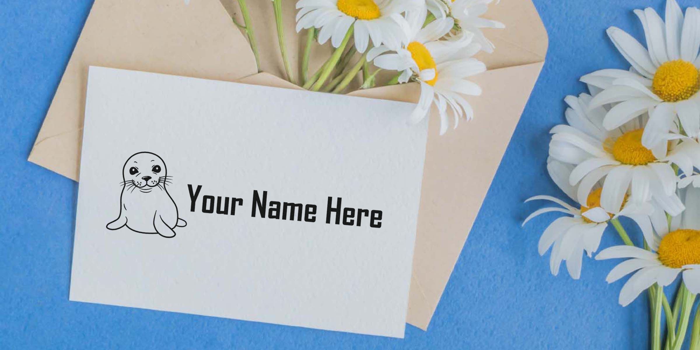 A white card with a cute seal illustration and the text “Your Name Here,” placed beside a bouquet of white daisies on a blue background.