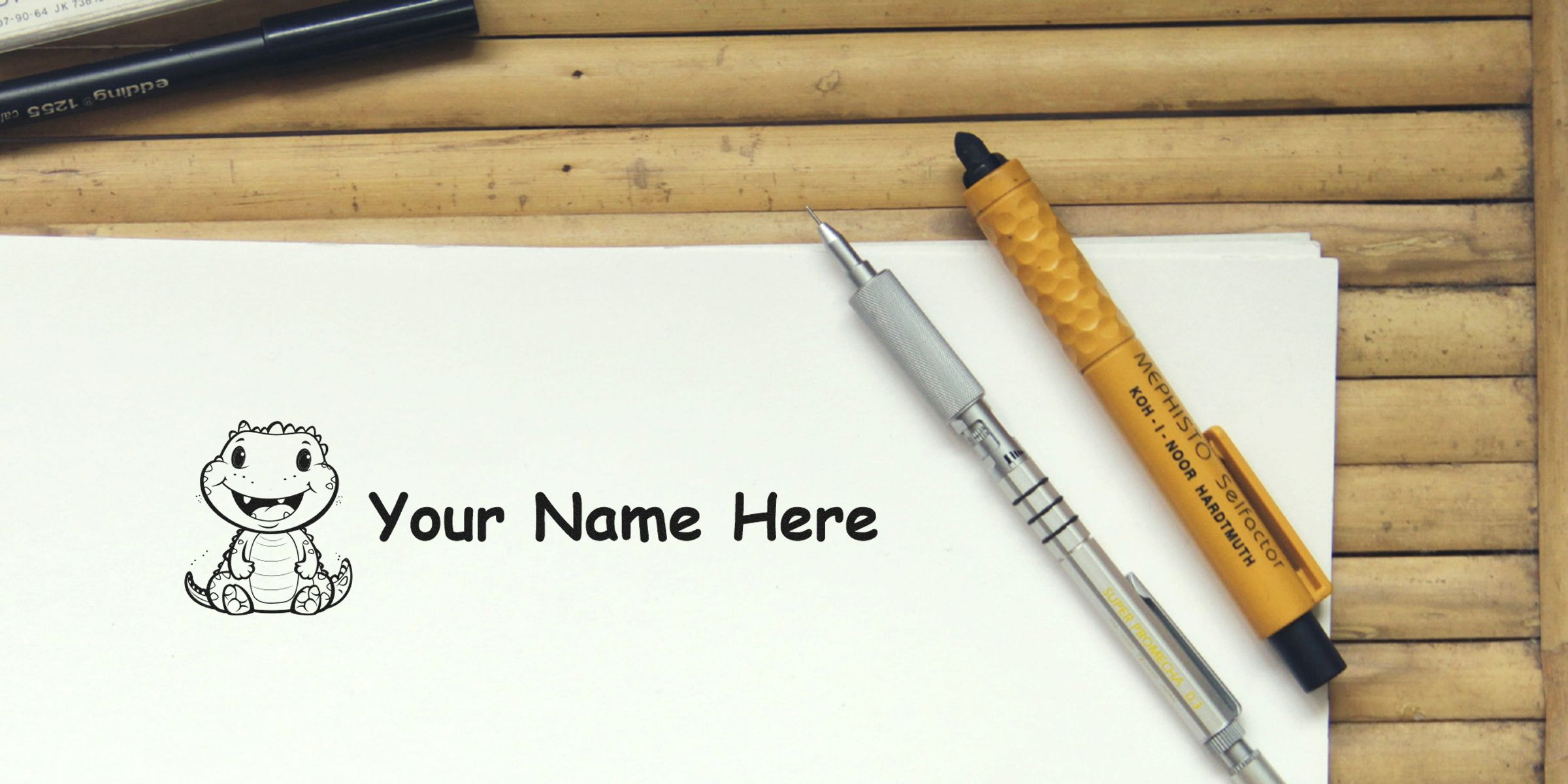 A white sheet with a cute dinosaur cartoon and the words “Your Name Here,” accompanied by pens on a wooden surface.