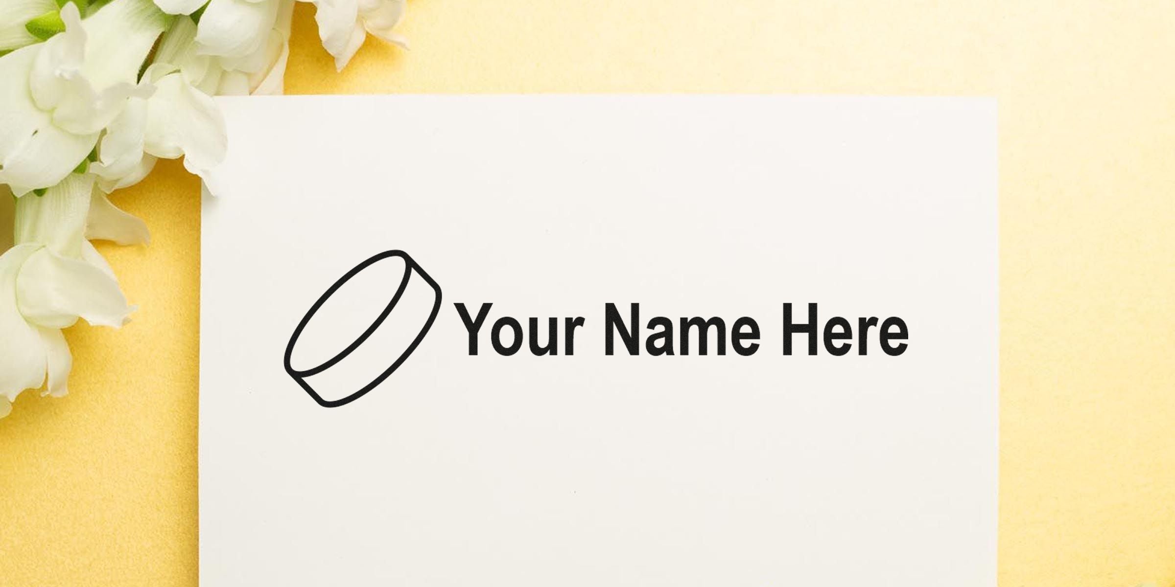 Card with the text “Your Name Here” and a simple ring illustration, beside white flowers on a yellow background.