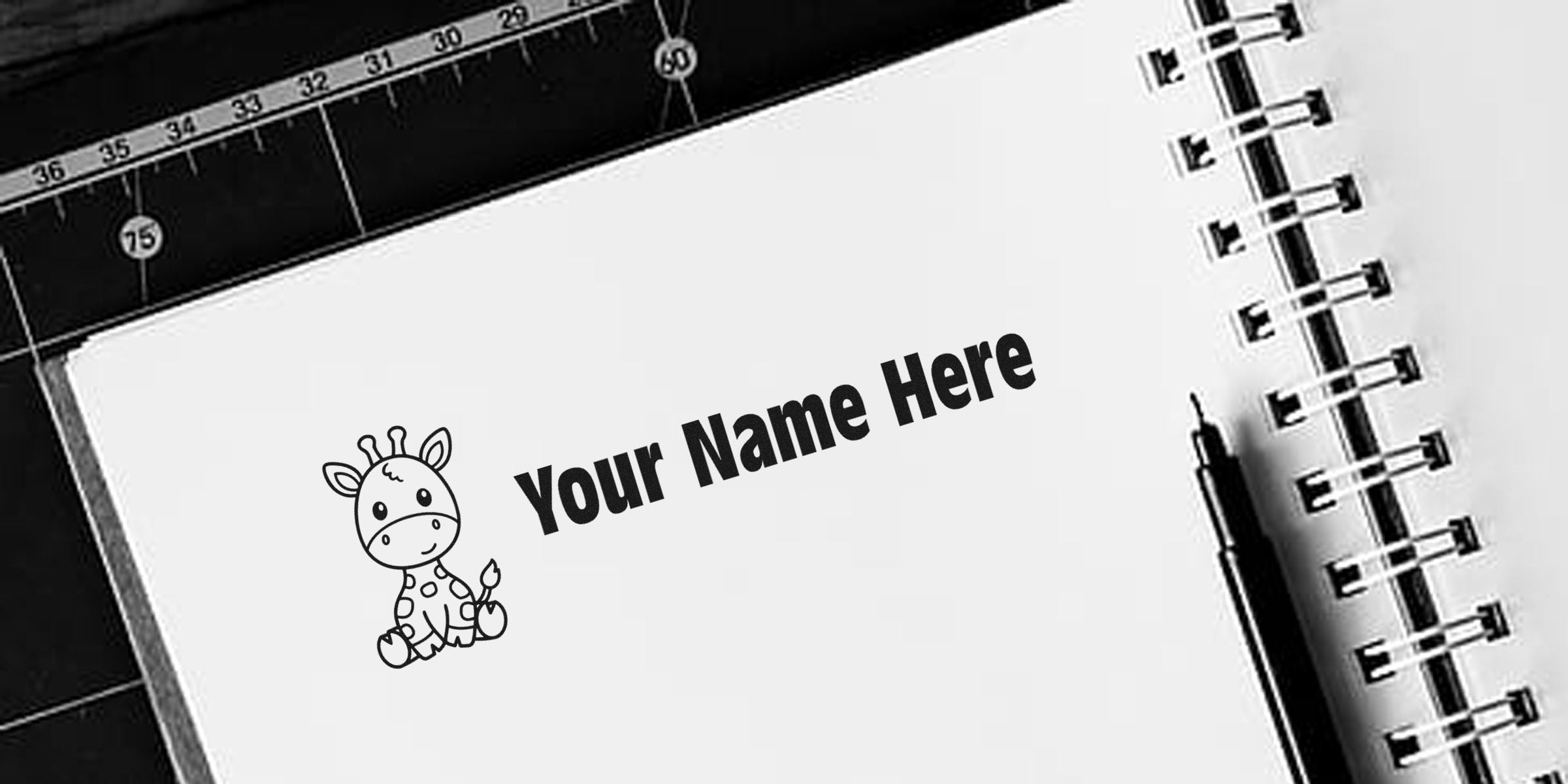 A cute baby giraffe illustration next to the text “Your Name Here” on a spiral-bound notebook.