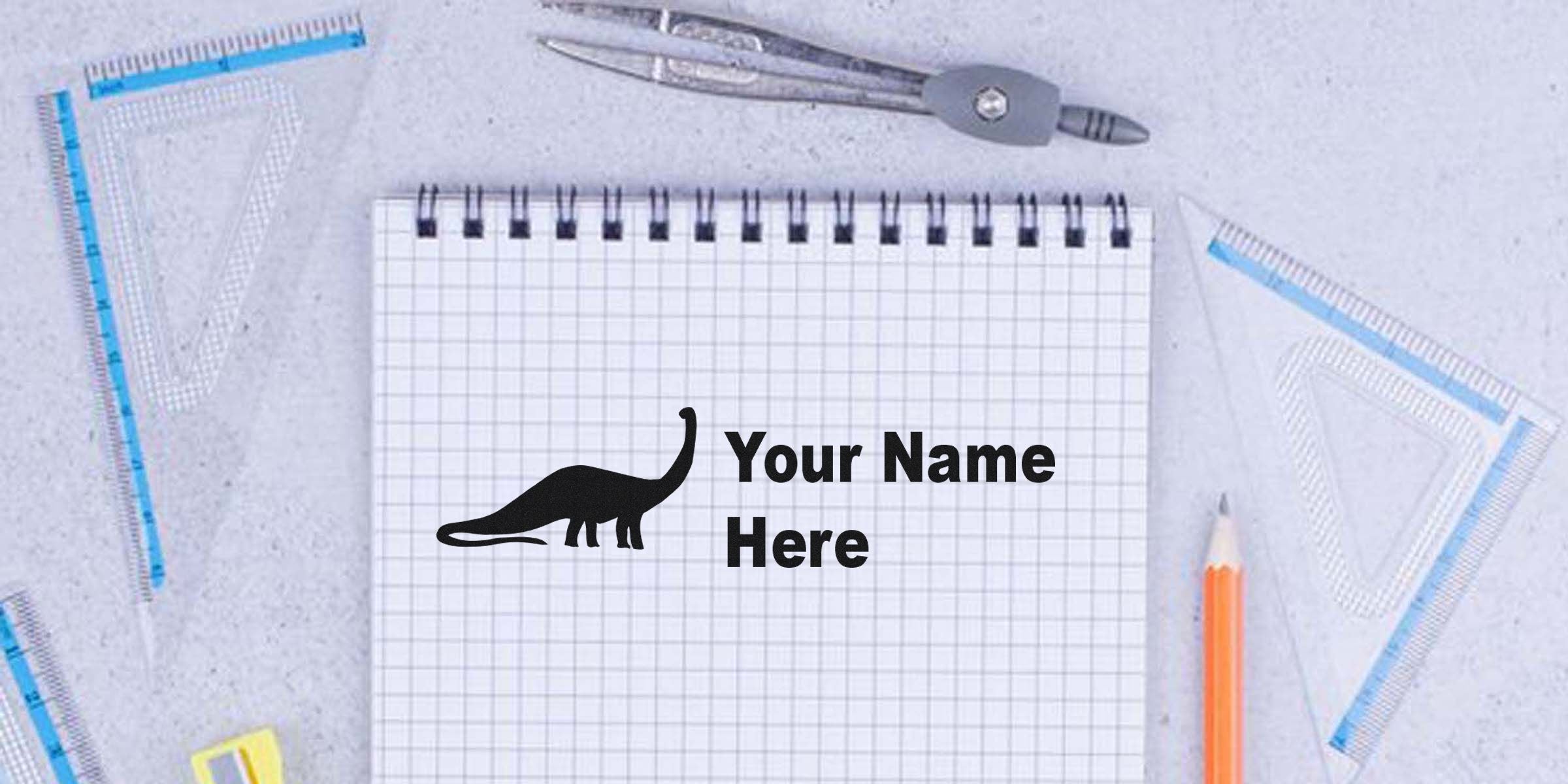 Notebook page with a dinosaur silhouette and the text "Your Name Here."