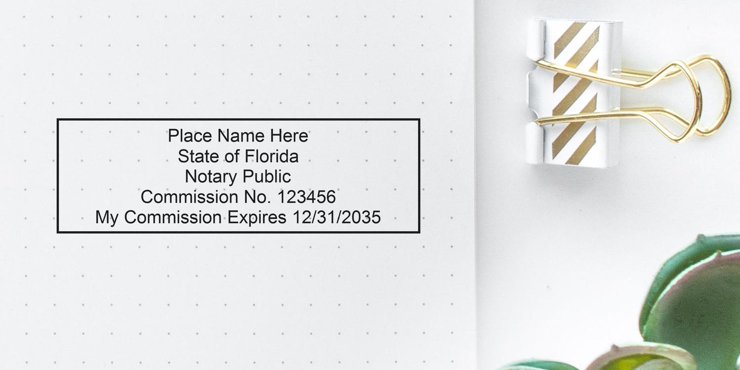 Notary public stamp template on dotted paper reading "Place Name Here, State of Florida, Notary Public, Commission No. 123456, My Commission Expires 12/31/2035" beside a gold binder clip and a succulent plant.