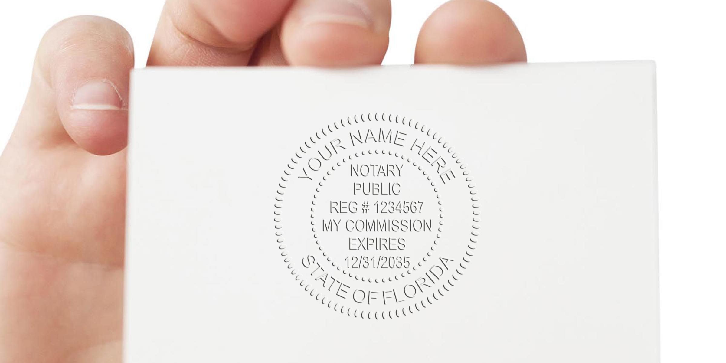Hand holding white business card with embossed notary public seal reading "Notary Public, Reg # 1234567, My Commission Expires 12/31/2035, State of Florida"