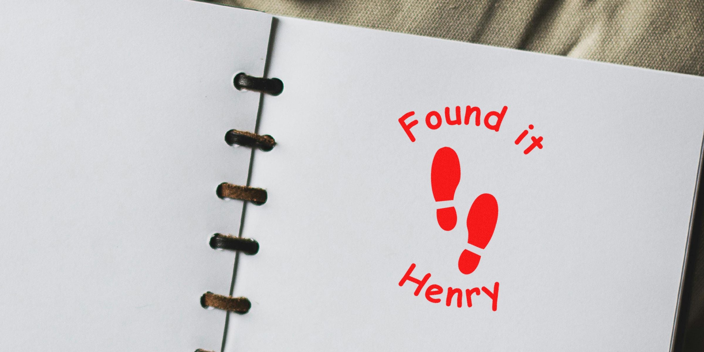 Red footprints icon with the words “Found it” and “Henry” on a white notebook page.