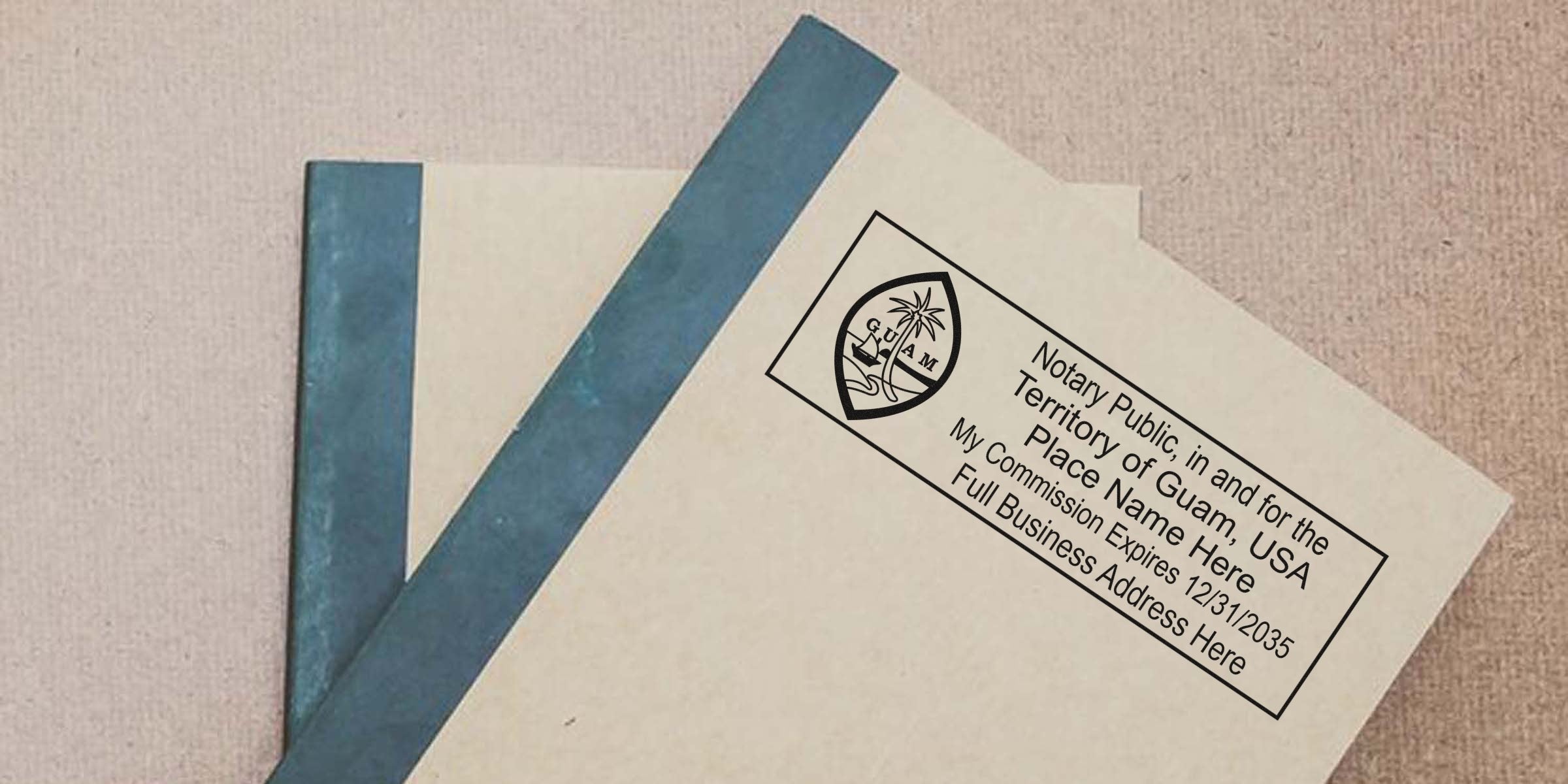 Beige envelope with Guam notary public stamp and emblem, labeled “Notary Public, Territory of Guam” placed atop a blue-bound notebook on a textured beige surface, close-up of notarized document and stationery.