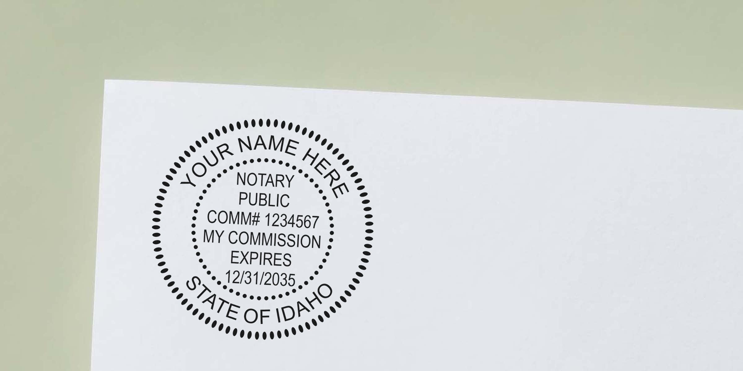 Round black notary public stamp impression on white paper reading "Your Name Here", commission number, expiration date and "State of Idaho" — mock notary seal for Idaho notary services