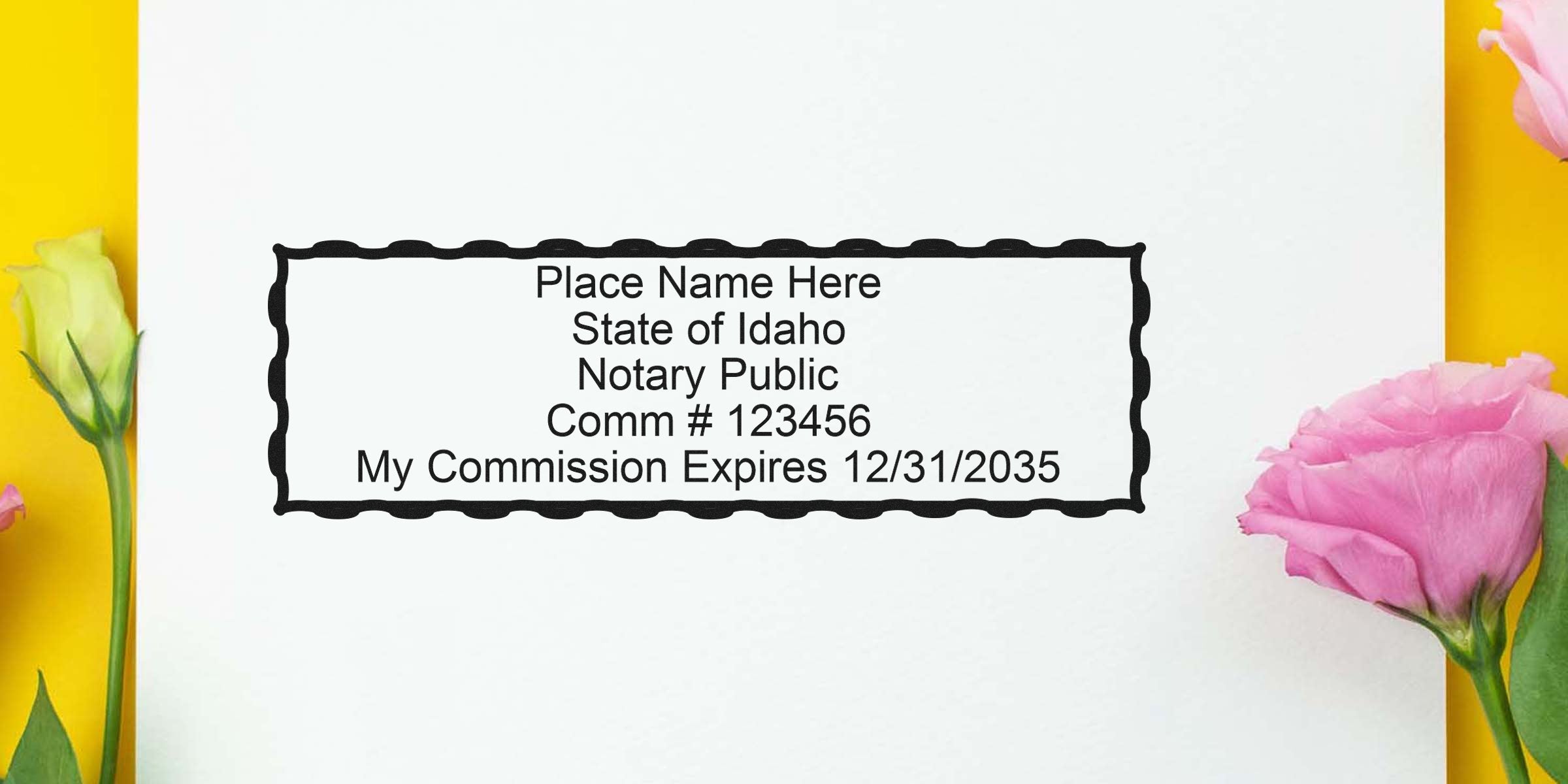 Idaho notary stamp sample on white paper with scalloped rectangular border reading "Place Name Here, State of Idaho Notary Public, Comm #123456, Commission Expires 12/31/2035" with pink and yellow flowers.