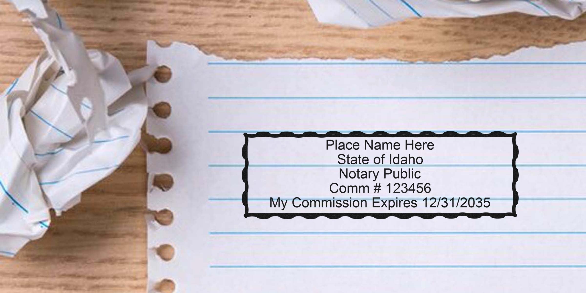 Torn lined notebook paper and crumpled scrap on a wood desk, showing a black scalloped mock notary stamp: "Place Name Here, State of Idaho, Notary Public, Comm #123456, My Commission Expires 12/31/2035"