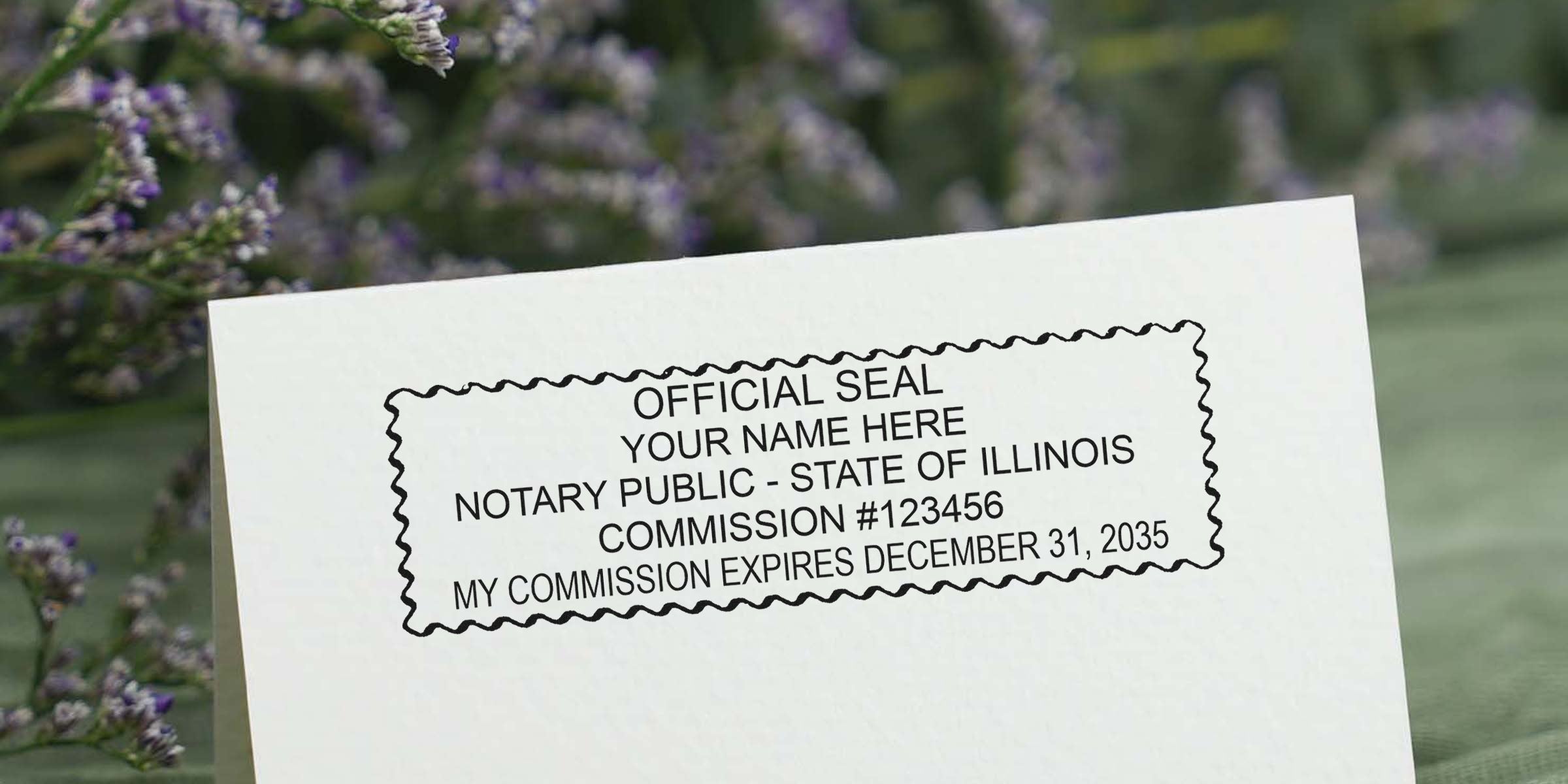 Notary public official seal stamp impression on a white folded card reading "OFFICIAL SEAL YOUR NAME HERE NOTARY PUBLIC - STATE OF ILLINOIS COMMISSION #123456 MY COMMISSION EXPIRES DECEMBER 31, 2035" with blurred lavender background