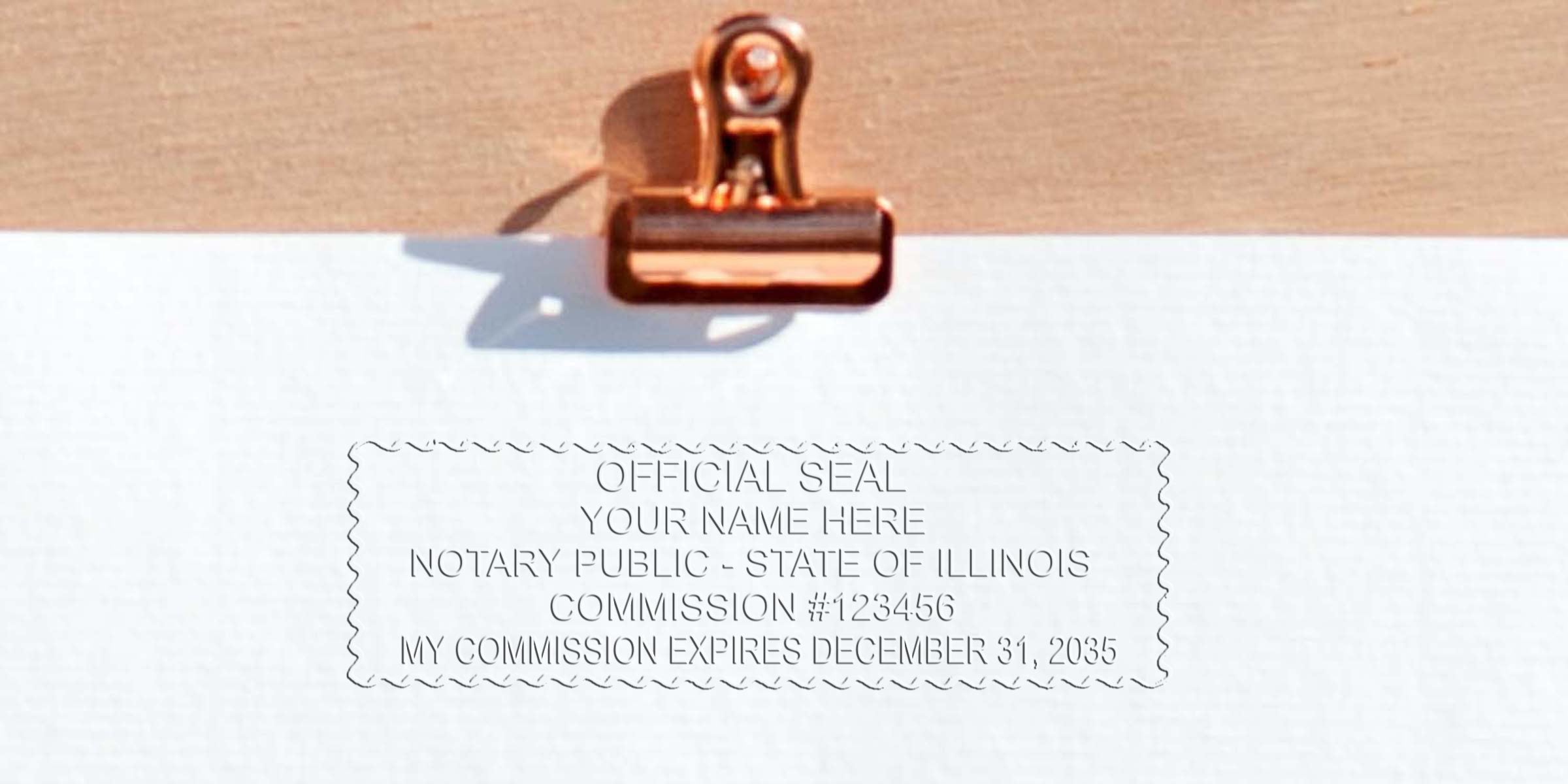 Copper binder clip holding white paper with an embossed rectangular notary public seal reading "Official Seal" for the State of Illinois.