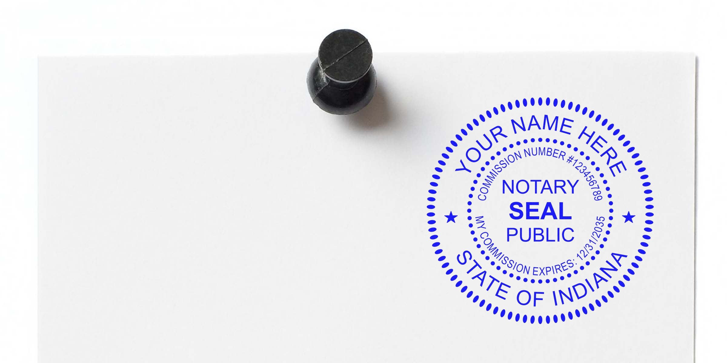 Blue circular notary public seal reading "NOTARY SEAL PUBLIC, STATE OF INDIANA" with placeholder "YOUR NAME HERE" and commission details, stamped on white paper held by a black push pin.