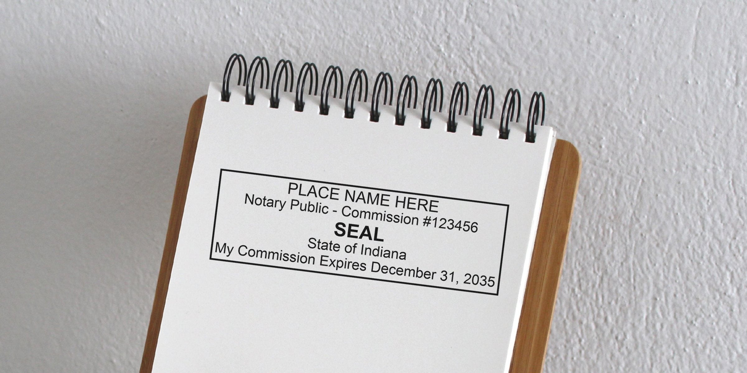 Top-bound spiral notepad displaying a printed notary seal template reading "SEAL State of Indiana" with commission number and expiration date.
