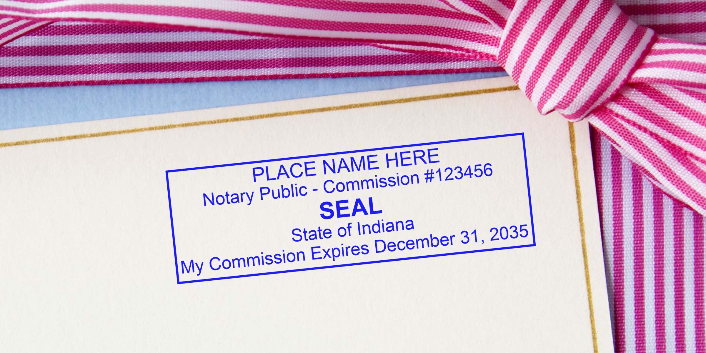 Blue notary public commission seal stamped on cream certificate corner with gold trim, pink and white striped ribbon bow, showing State of Indiana and commission expiration date.