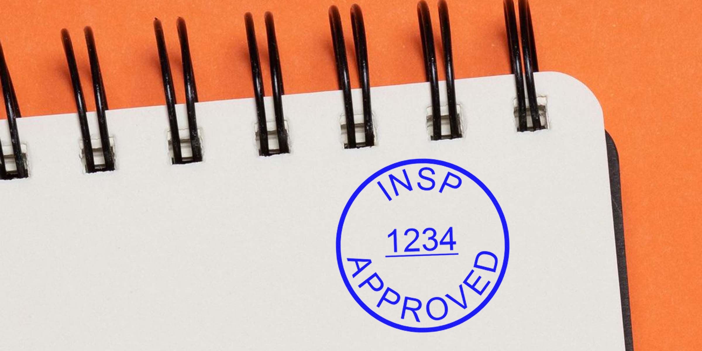 Notebook page with a blue circular stamp reading “INSPECT APPROVED” and the number 1234 underlined.