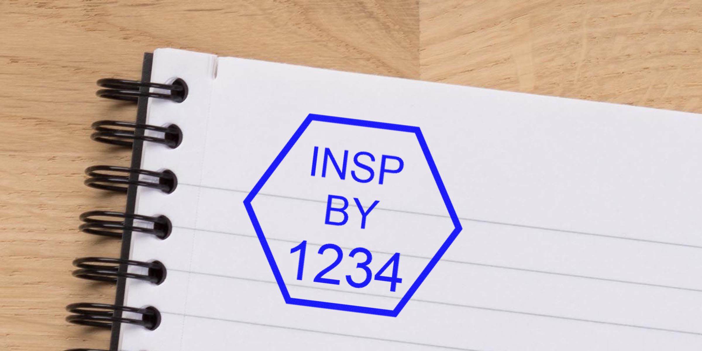 Blue hexagon logo with the words INSP BY 1234 on a spiral notebook page.