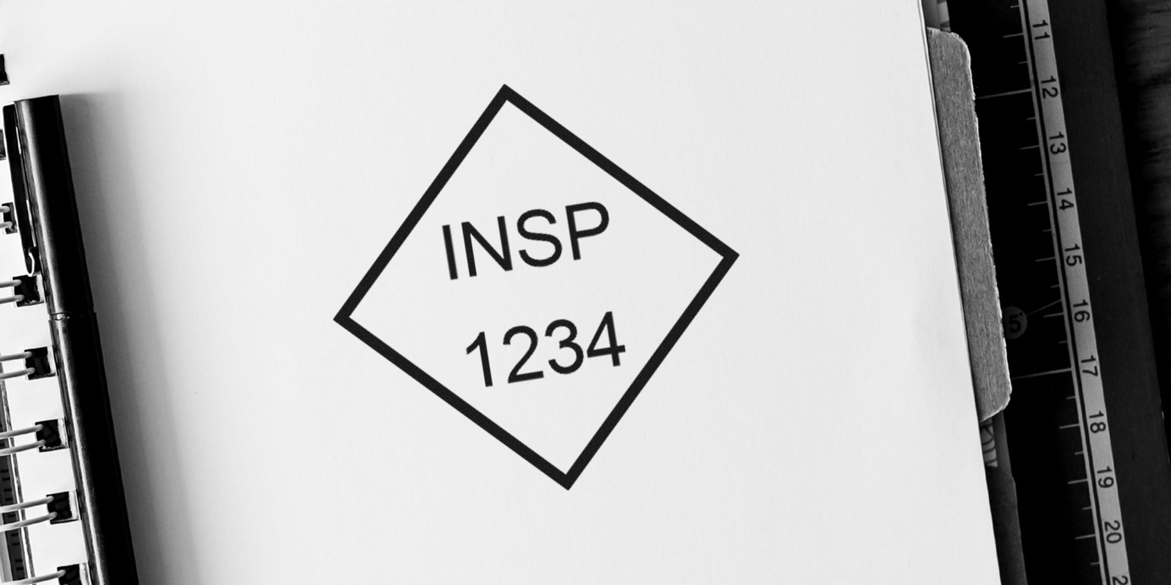 Diamond-shaped label with the words “INSP” and the number “1234” on a white page.