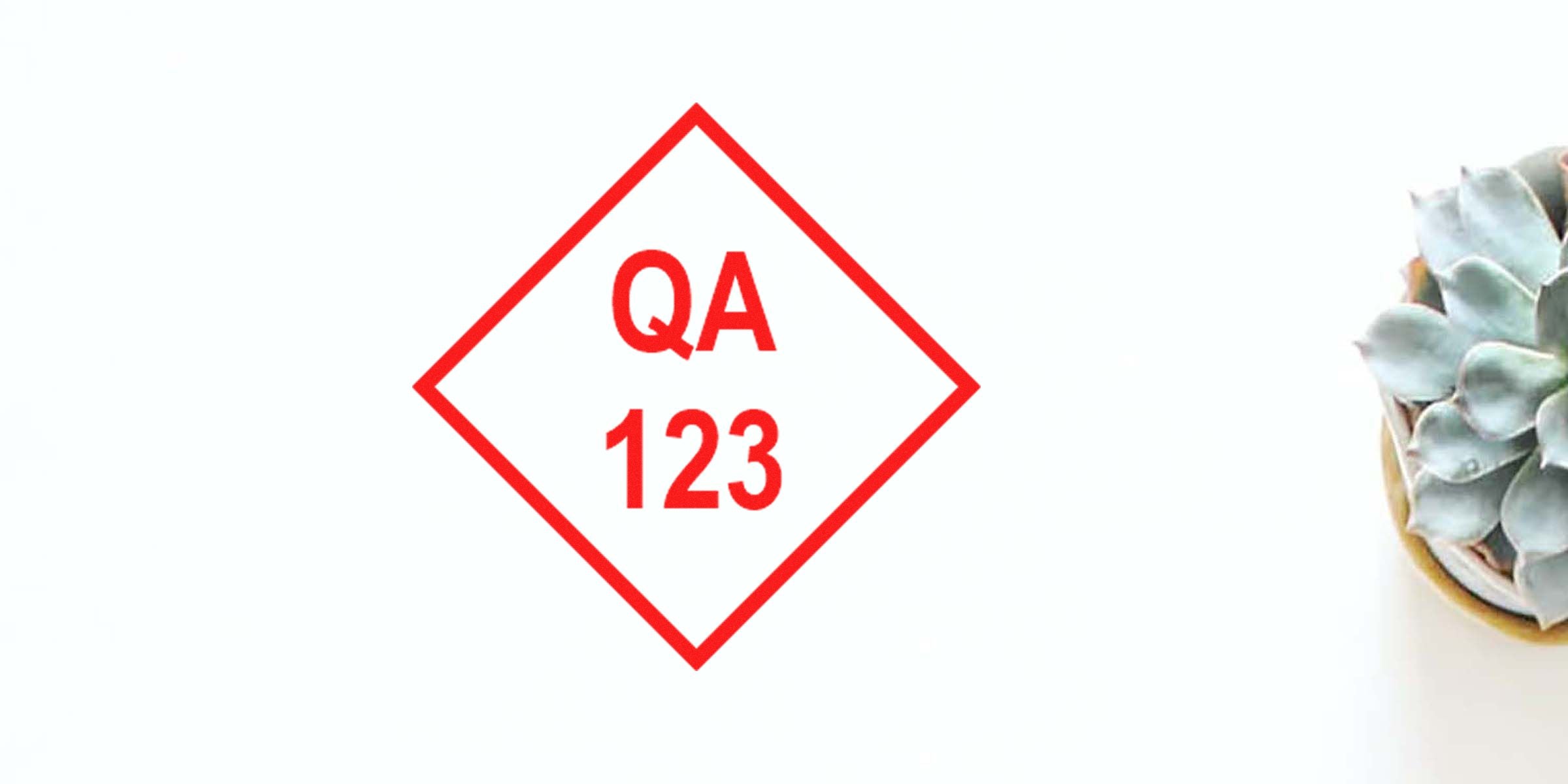 QA 123 shown in red inside a diamond-shaped sign on a white background, with a succulent plant on the right.