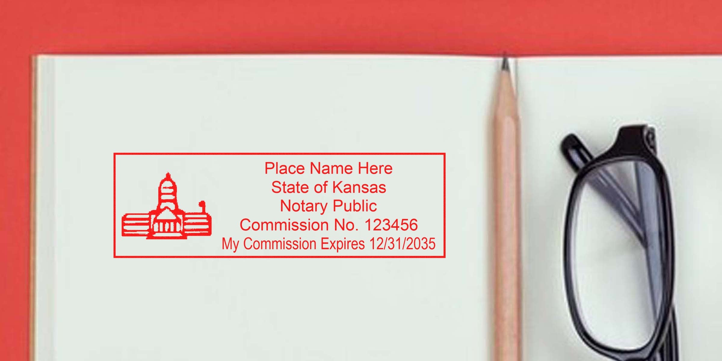 Red Kansas notary public stamp imprint on an open notebook beside a pencil and eyeglasses, rectangular seal with capitol icon and placeholder name, commission number and expiration date.