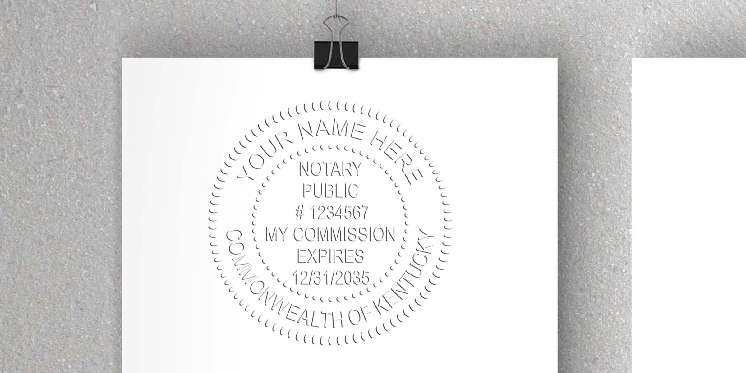 Embossed notary public seal mockup on white paper clipped to a gray textured wall, circular design reading "Your Name Here," "Notary Public," sample commission number and expiration date, Commonwealth of Kentucky.