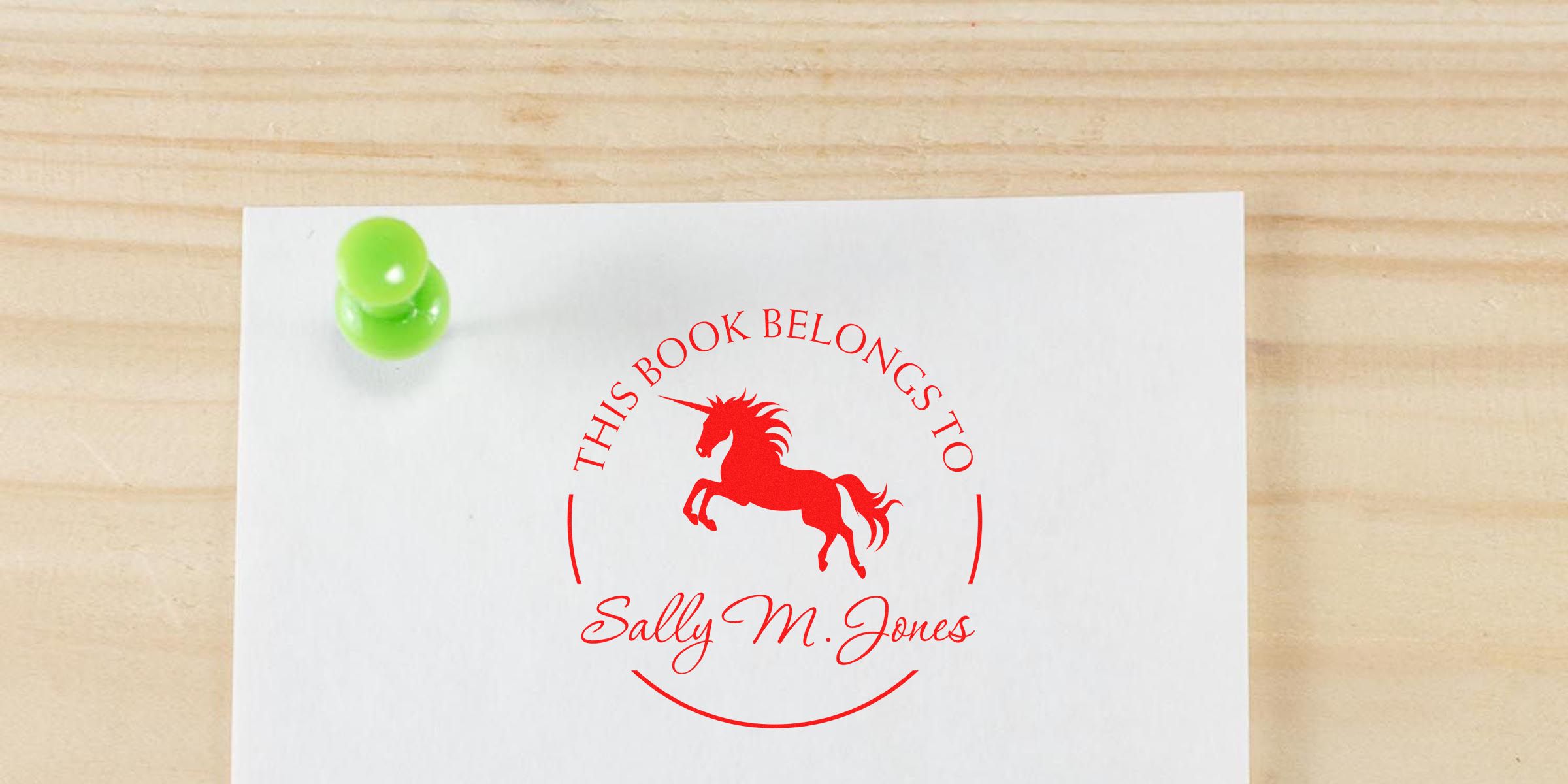 Stamped book label: red circle with “This Book Belongs To” around a red unicorn, and the name “Sally M. Jones.”