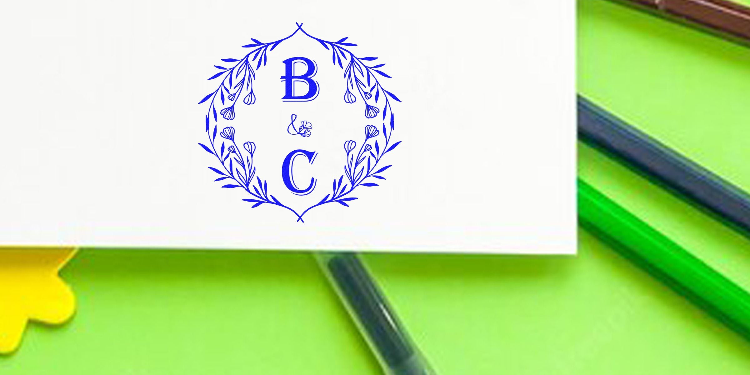 Blue floral circular monogram with the letters B and C and a small ampersand in the center.