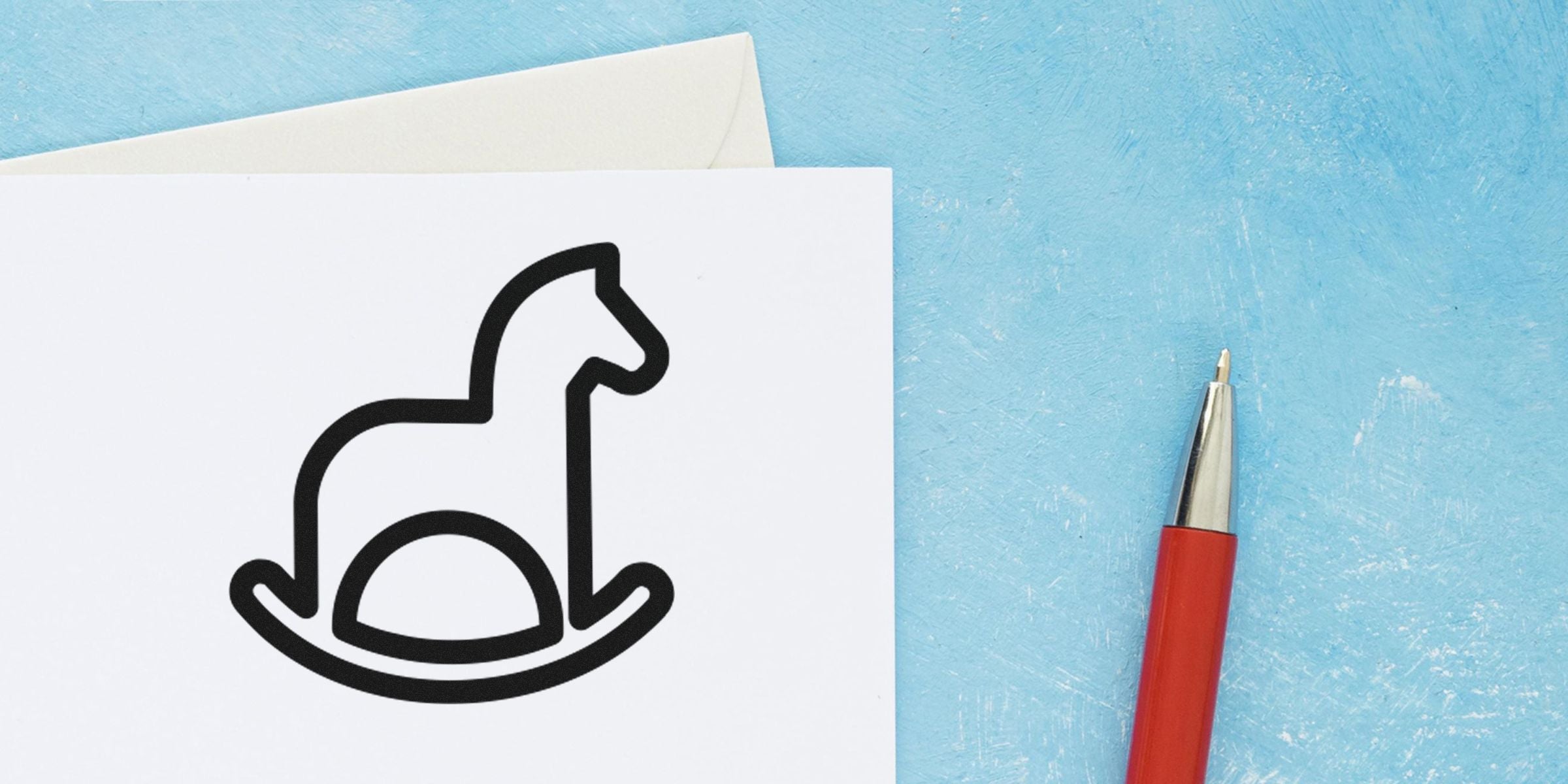 Line drawing of a dog icon on a white card with a red pen on a blue surface.