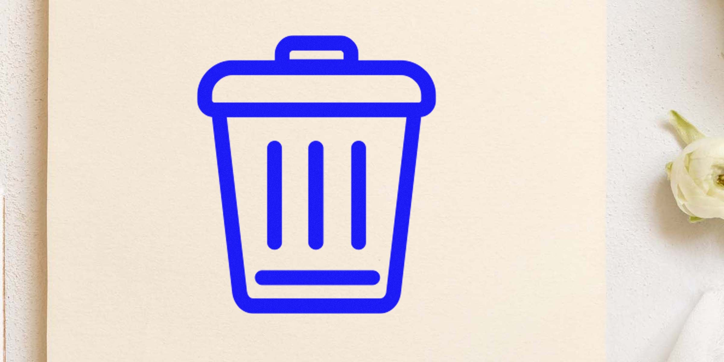 Blue trash can icon on a light beige background.
