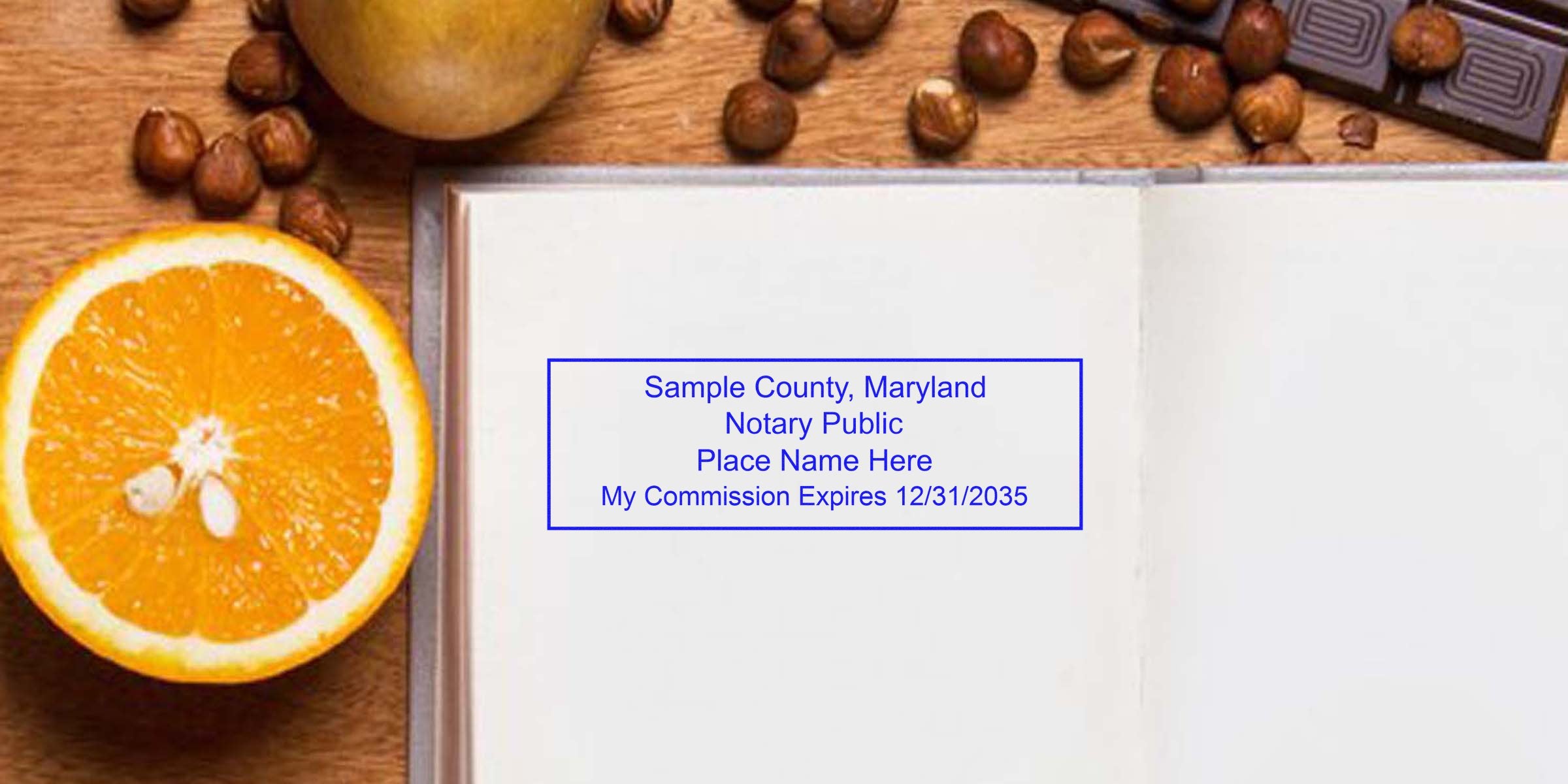 Open notebook page with blue sample notary public stamp reading "Sample County, Maryland… My Commission Expires 12/31/2035", sliced orange half, scattered hazelnuts and chocolate on wooden table, flat-lay office and food composition