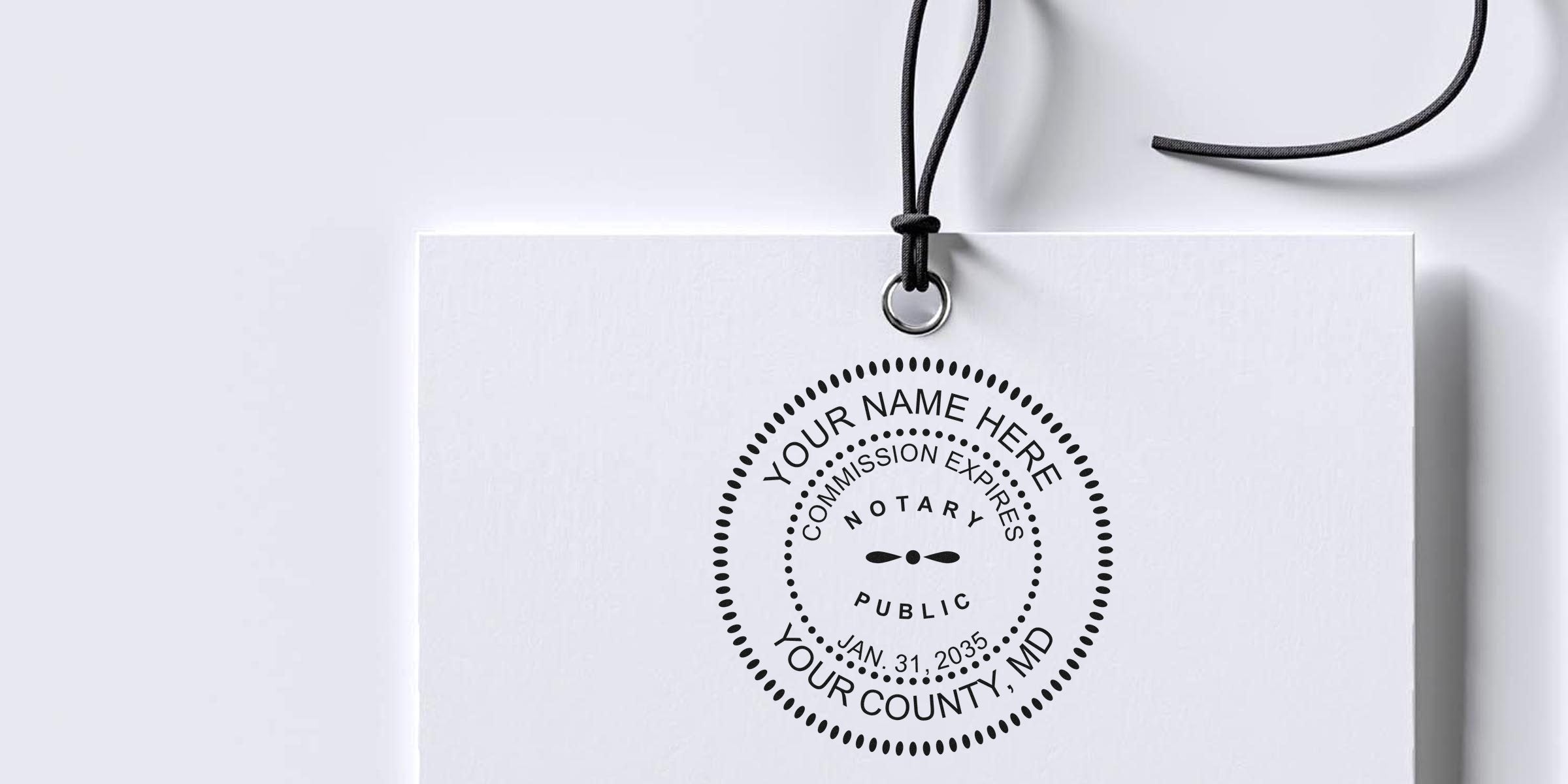 White hanging tag mockup featuring a black circular notary public stamp design with placeholder name, county, commission expiration text and a black cord loop.