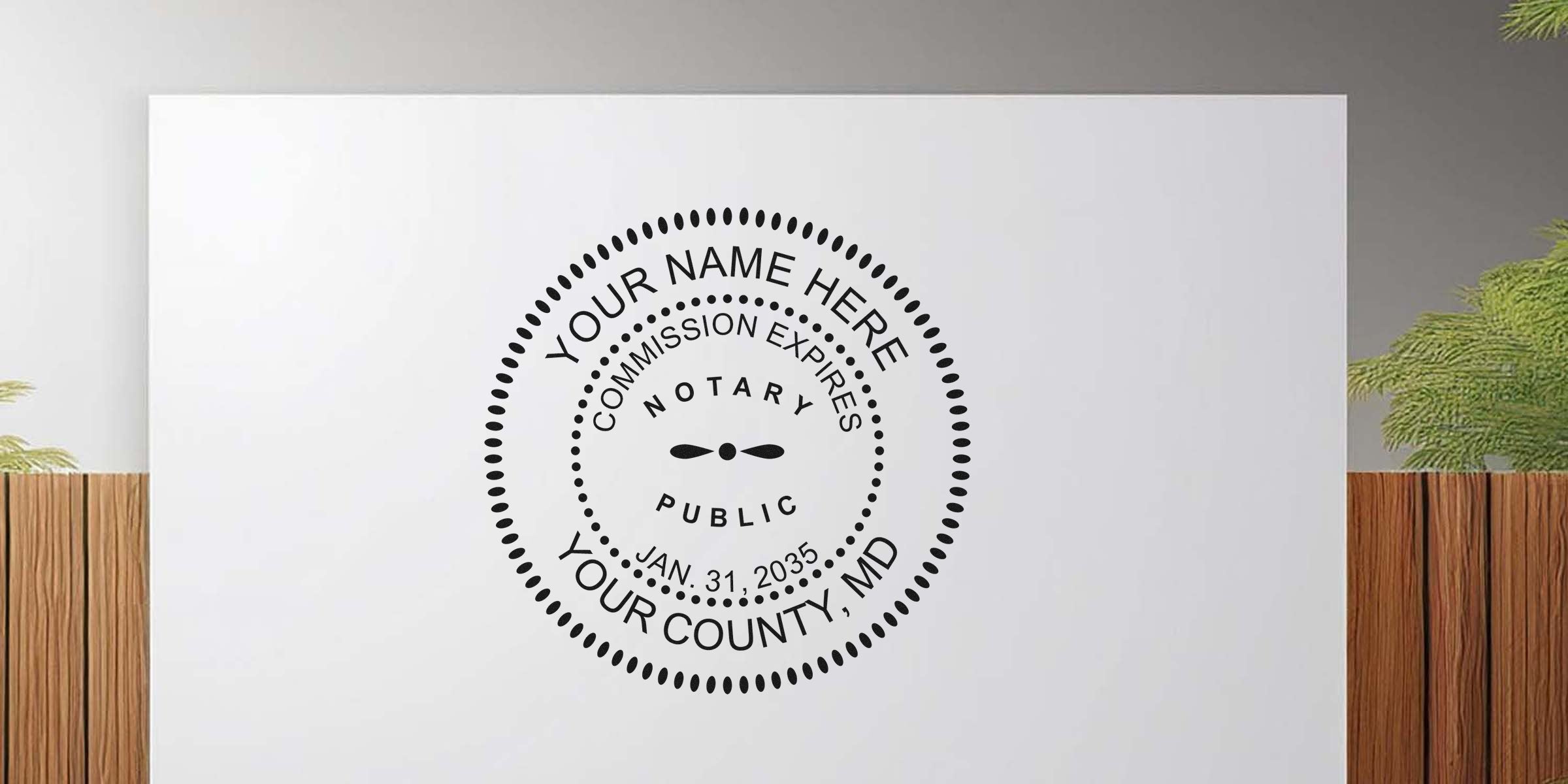 Black circular notary public stamp graphic on white background with dotted border, placeholder text "Your Name Here", "Your County, MD", "Commission Expires Jan. 31, 2035" — minimalist wall decal mockup