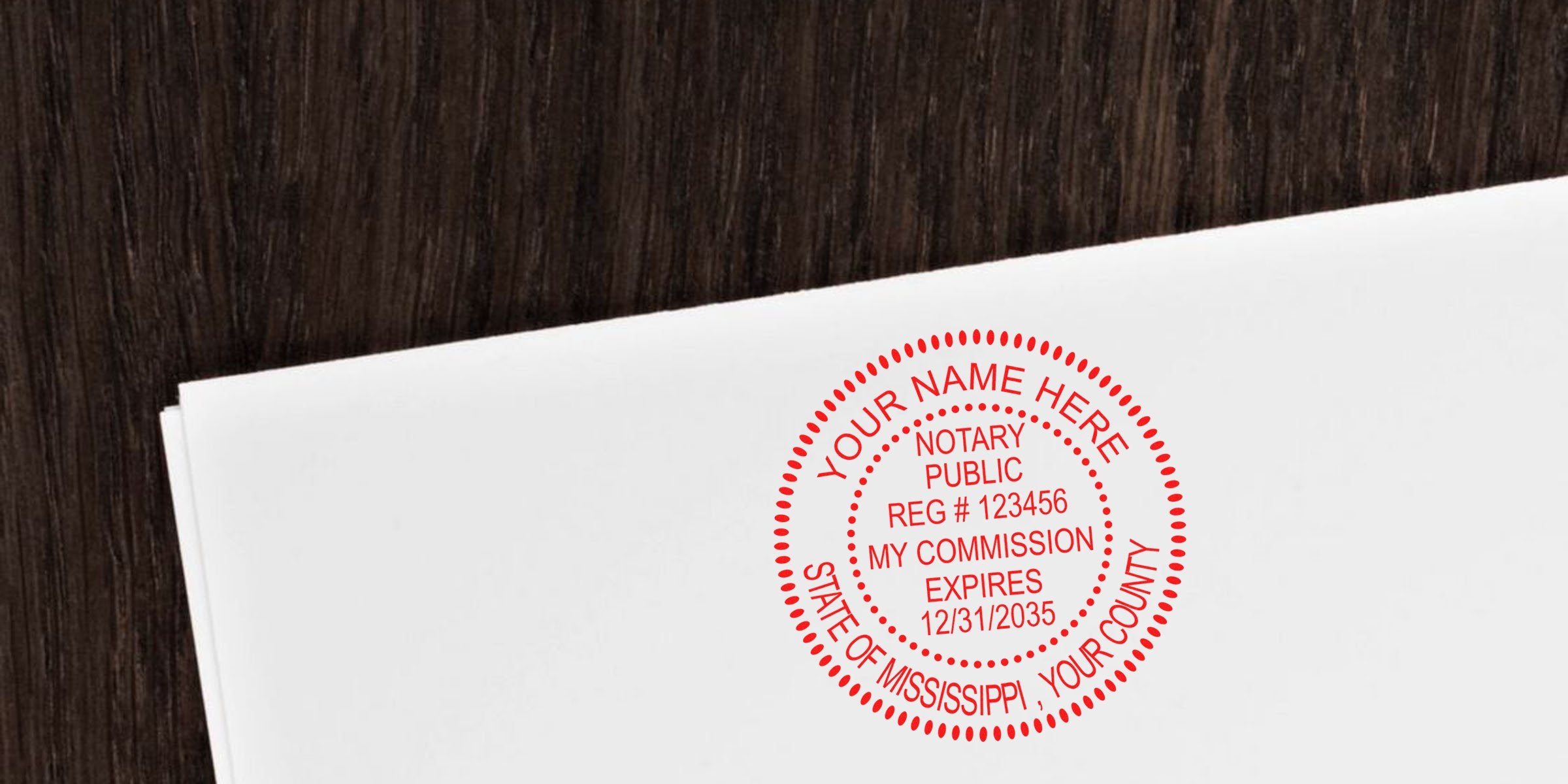 Red circular notary public stamp on a white envelope over dark wood, showing customizable name, registration number, commission expiration date and state/county designation.