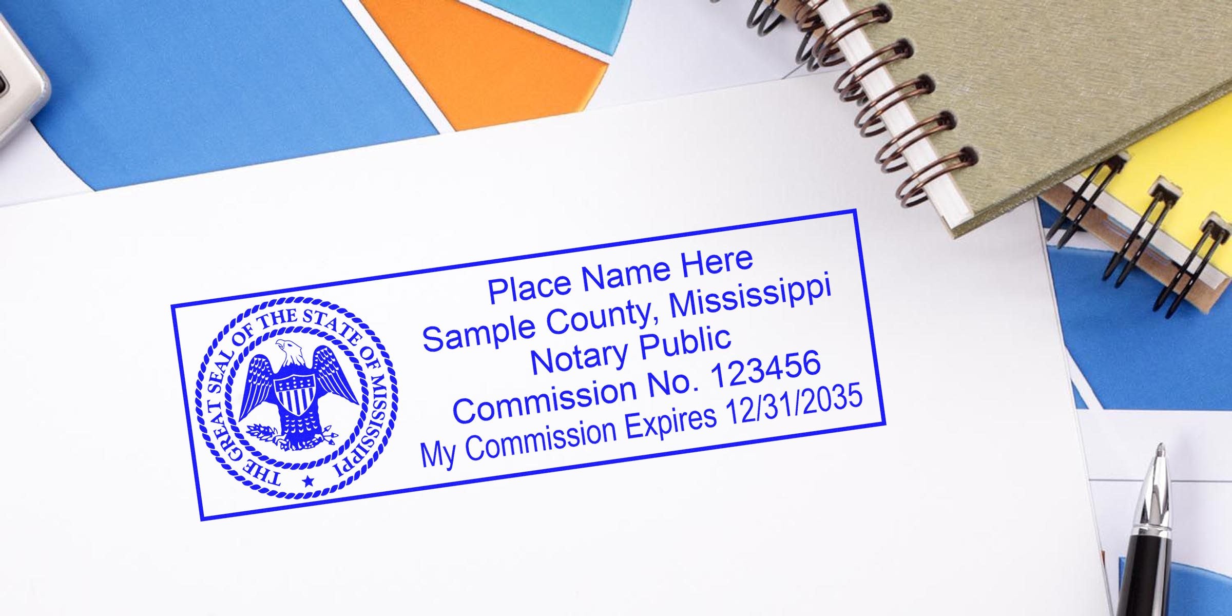 Blue Mississippi notary public stamp on paper with state seal, sample county and commission number, expiration date, surrounded by notebooks and pen